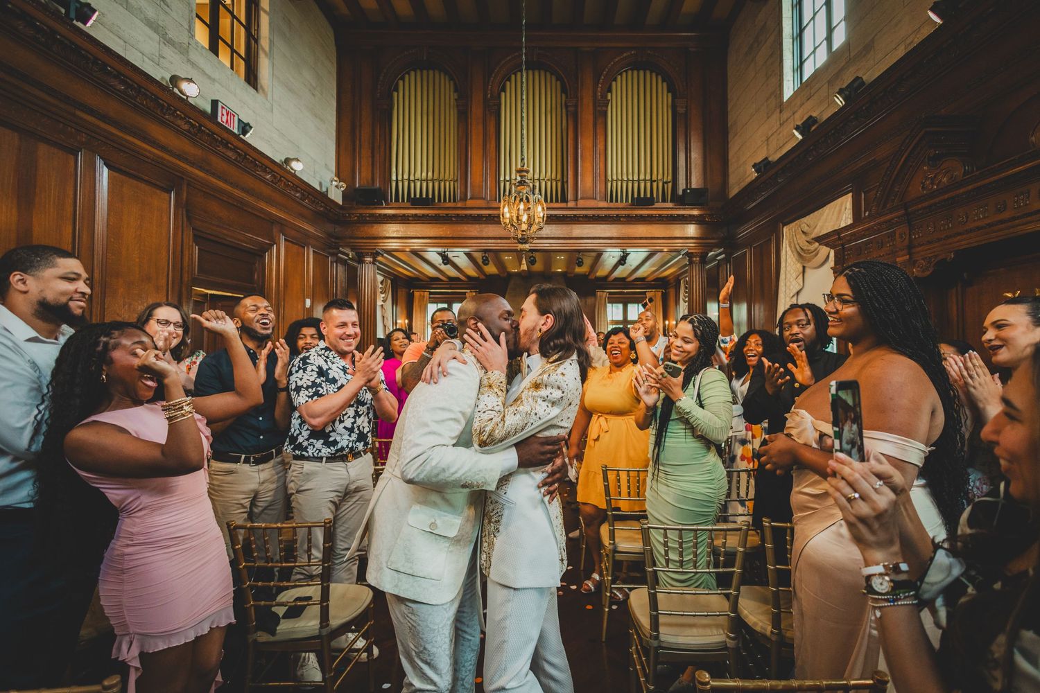 Grooms kissing at wedding