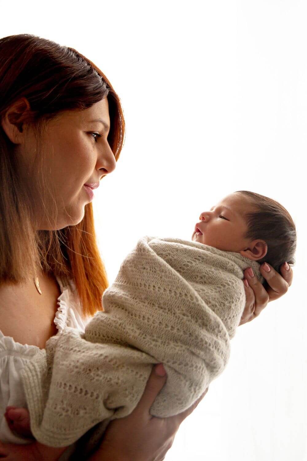 Newborn photography Sydney featuring sleeping baby boy in mummy's cuddle by Azi Khoshkam