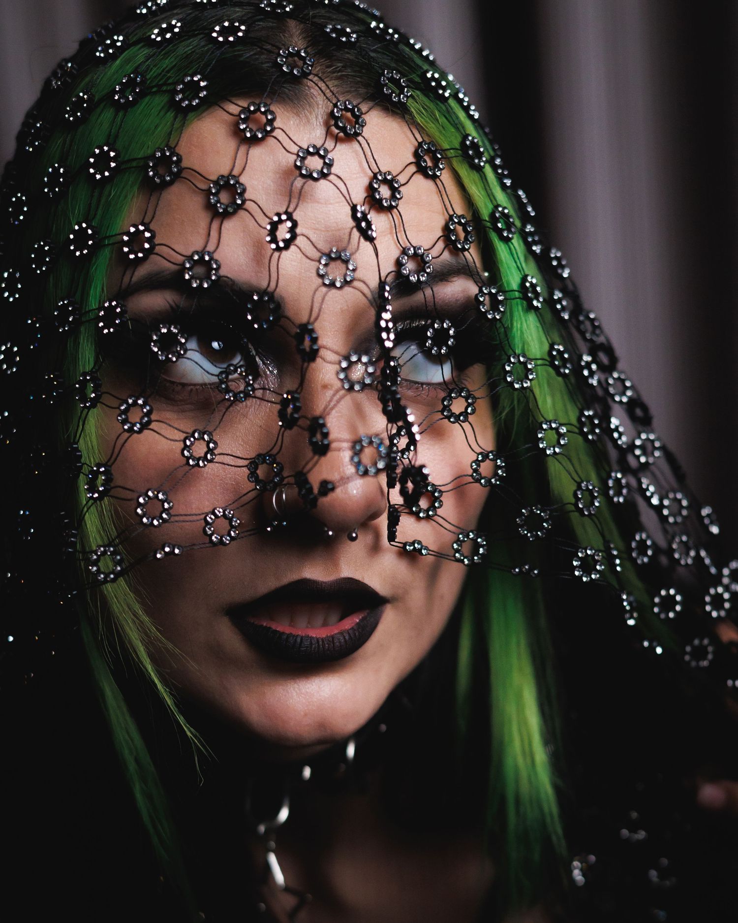 Dramatic portrait of a woman with green hair wearing a jeweled veil — creative portrait photography in Littleton, CO.