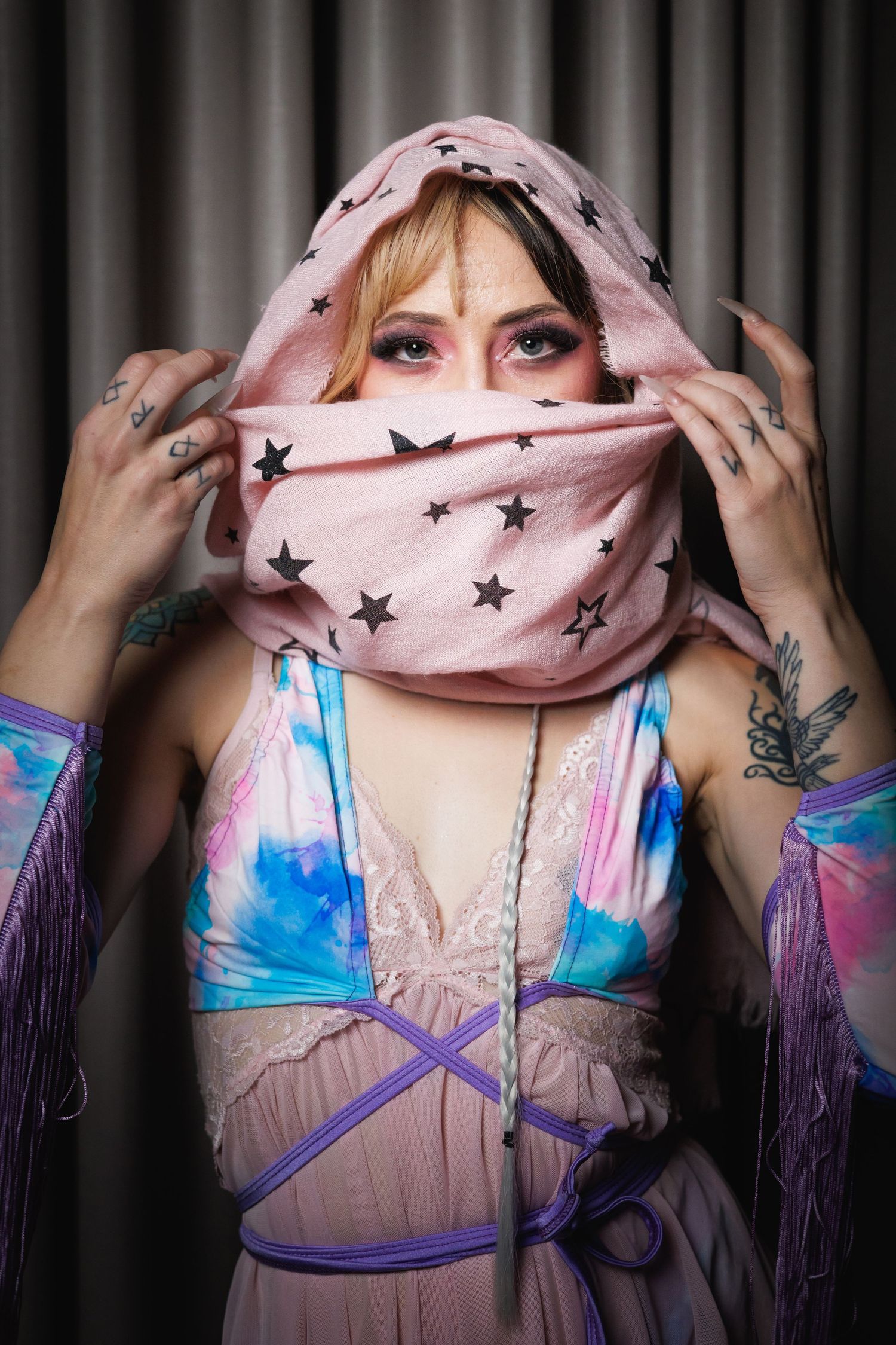 Edgy creative portrait — woman with pink scarf covering her mouth and visible tattoos, editorial portrait photography in Littleton, CO.