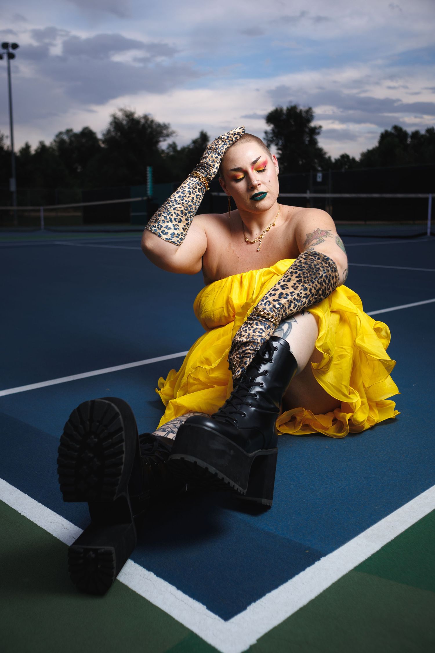 Senior portrait session on a tennis court — woman in bright yellow outfit, Littleton, CO by Graham Tipton.