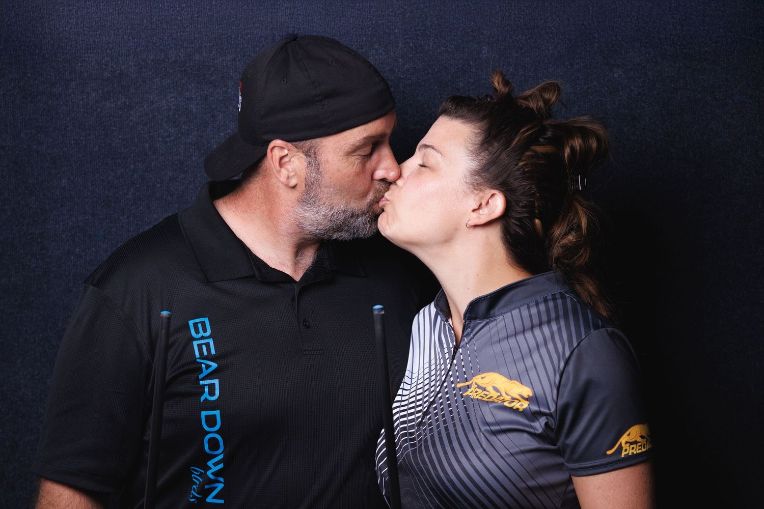 pool couple kissing in a pool hall