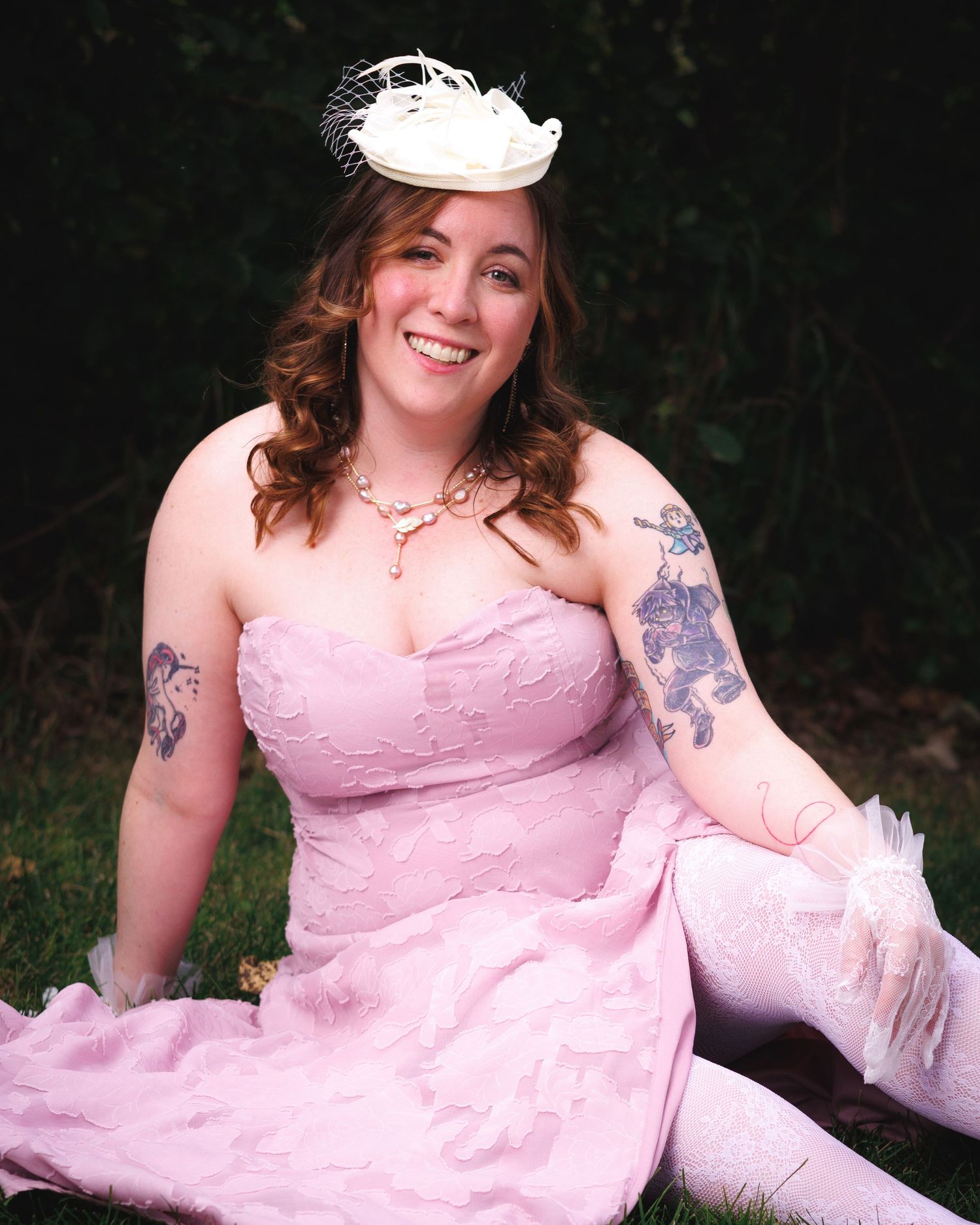 Outdoor portrait of a woman in a pink strapless dress with a floral headpiece — Littleton, CO senior photography.