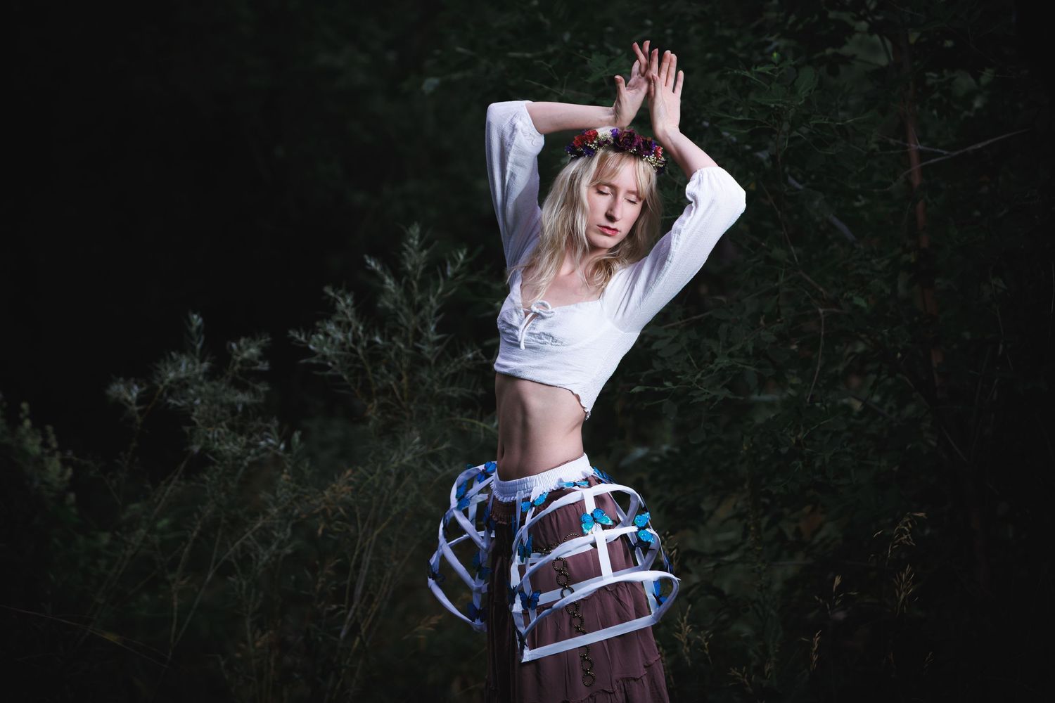 Moody creative outdoor portrait — blonde woman with arms raised at twilight, editorial portrait photography in Littleton, CO.