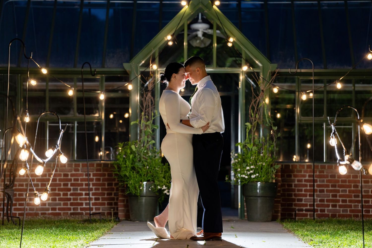 Nighttime bride and groom portrait at The Gardens at Elm Bank, MA. Light and airy wedding photography with twinkle lights.