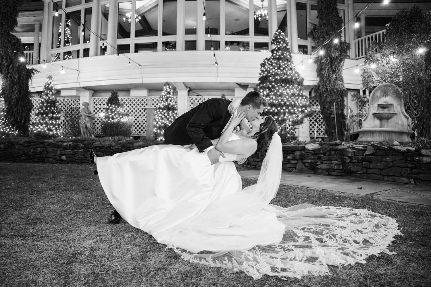 Light and airy black and white wedding photography at Bedford Village Inn, Bedford, NH, featuring a romantic bride and groom kiss.