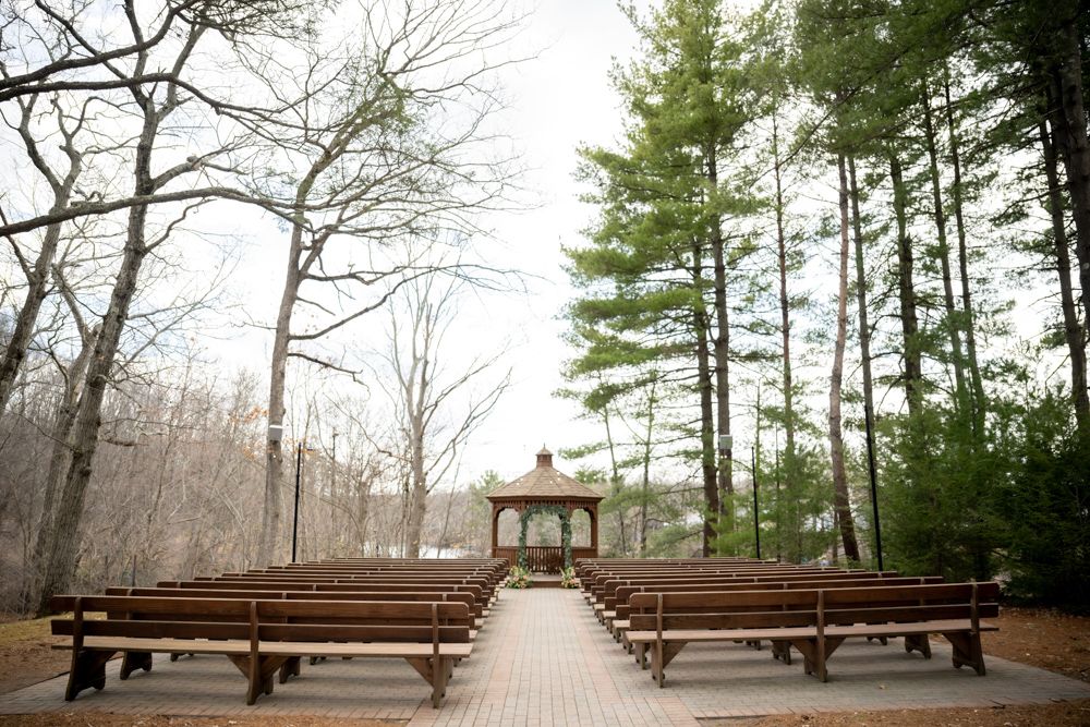 Empty lakefront ceremony setup at Pavilion on Crystal Lake featuring floral decor by Fountain Head Floral Design.