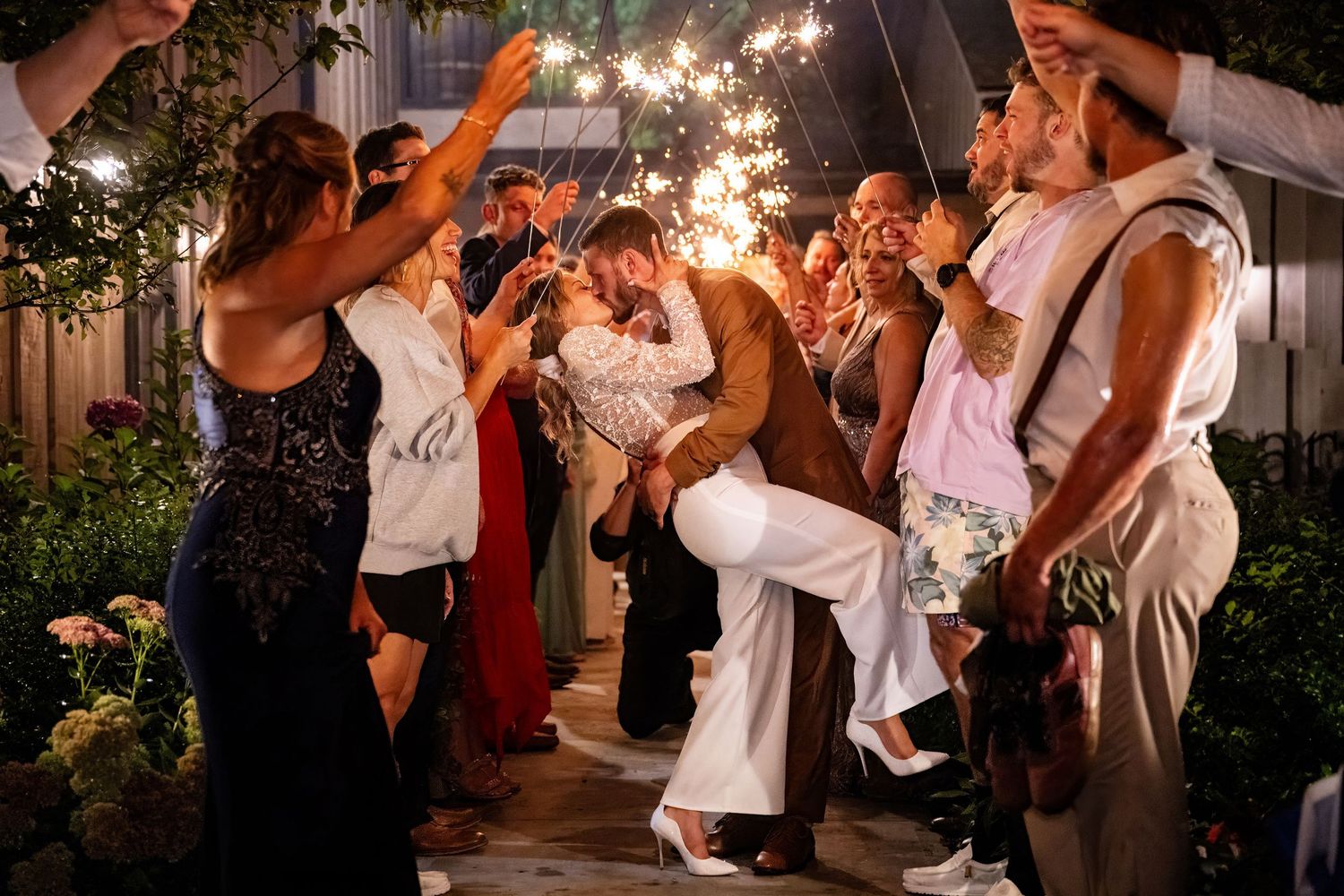 Sparkler exit kiss at Stonehurst at Hampton Valley, CT. Light and airy nighttime wedding photography by Allison Mott.