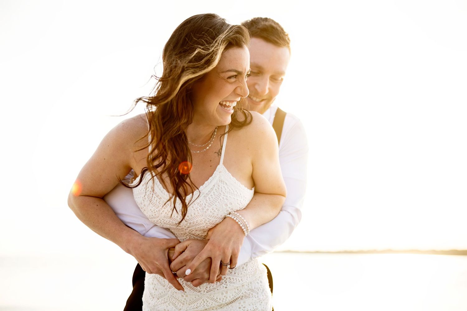 Light and airy engagement photography on the Connecticut River, featuring a joyful couple on a boat near Essex, CT.