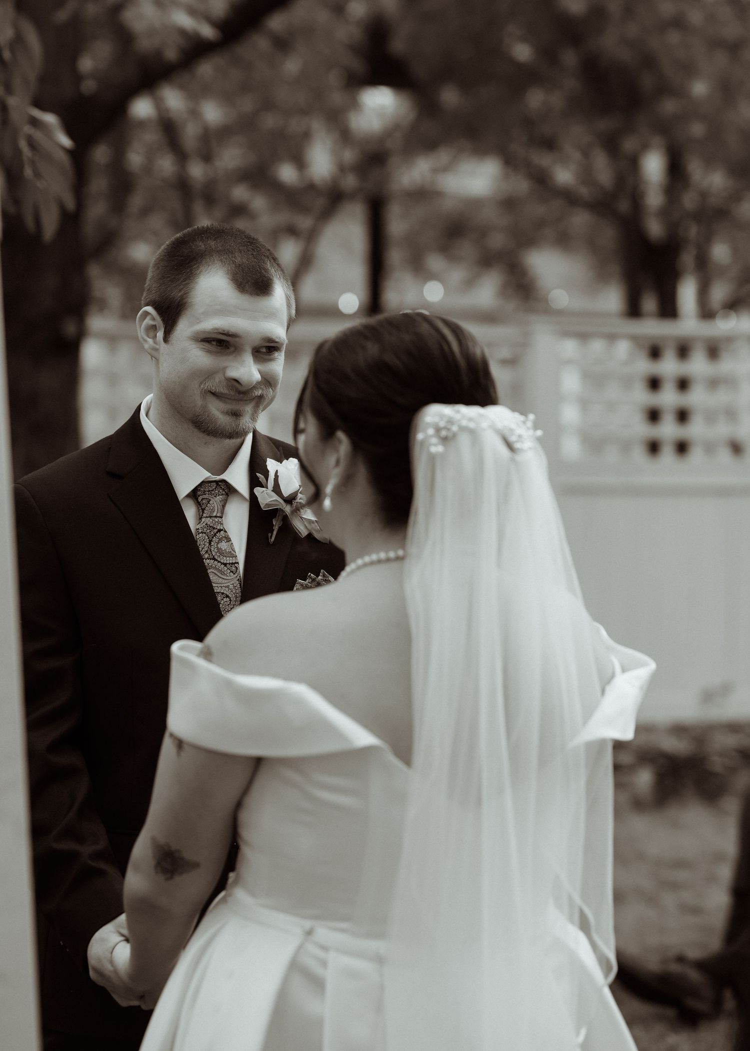 A black and white wedding photo collage showing intimate moments between a bride and groom during their celebration.