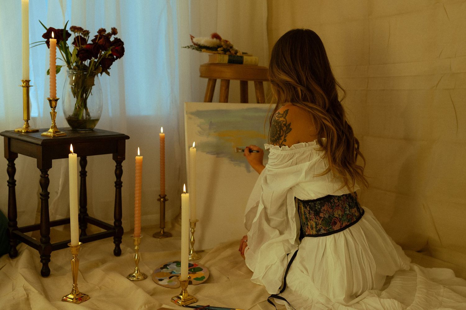 An indoor wedding photo series with candlelit decor and flowing white dress details.
