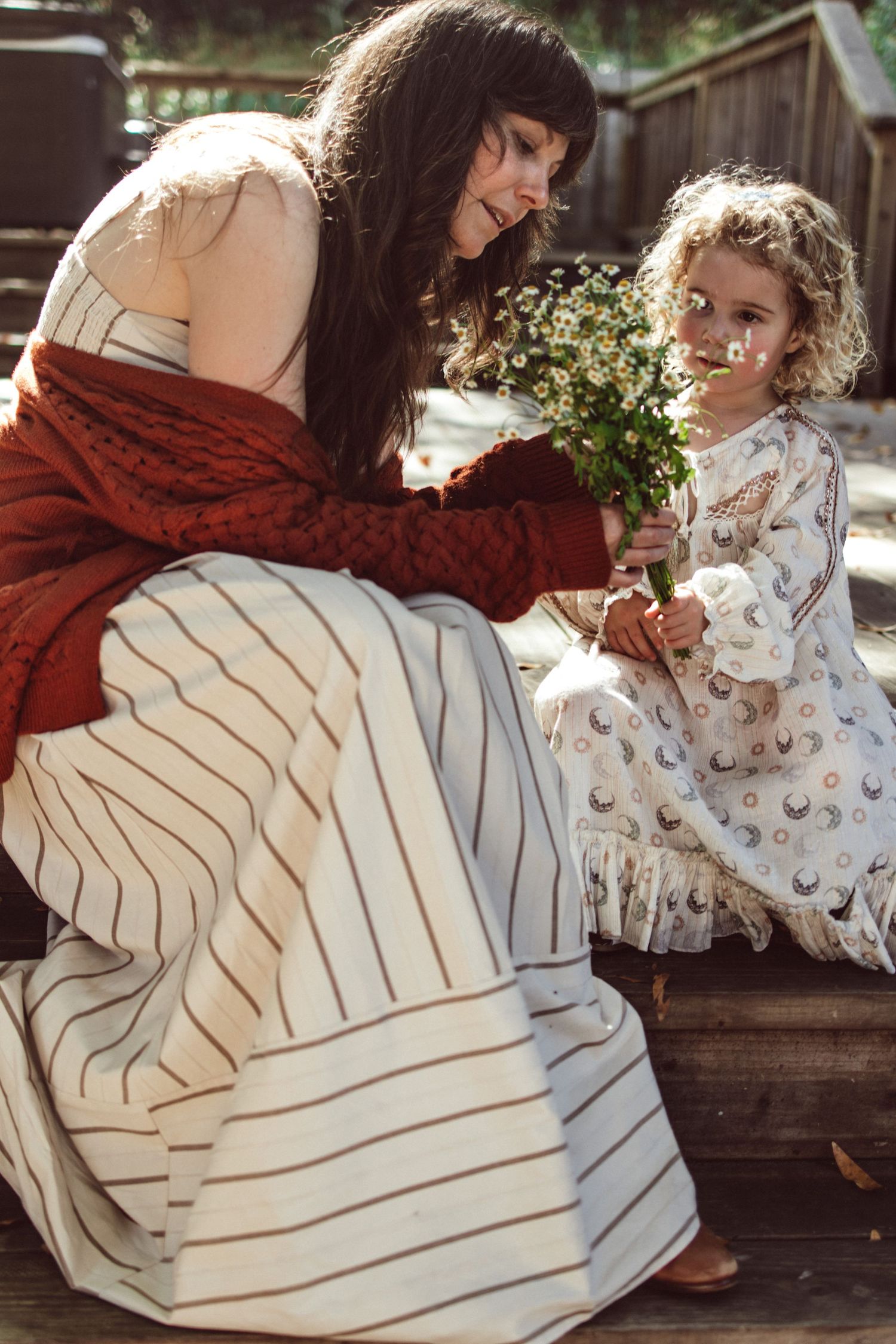 Sweet interaction captured on a wooden porch in natural lighting.
