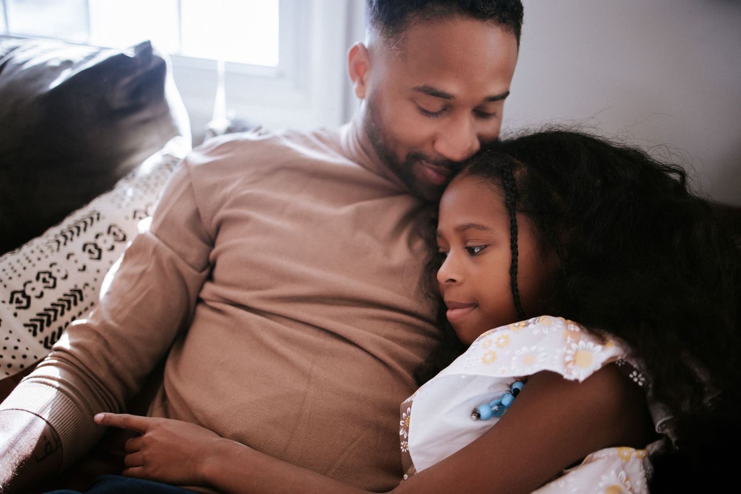 Tender family moment captured in soft indoor lighting.