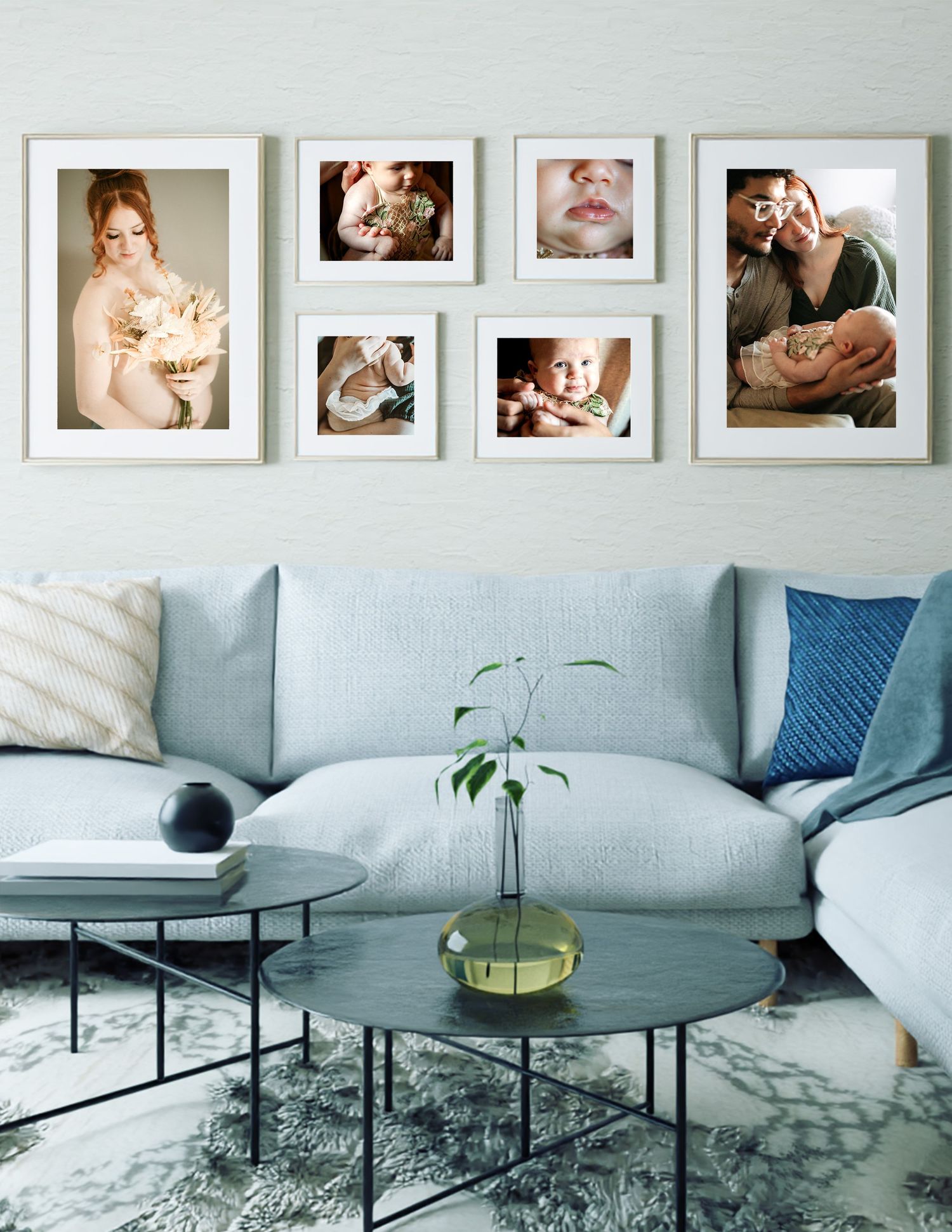 Modern living area with gallery wall and light gray sectional sofa accompanied by a gallery of luxury framed prints of a maternity session.