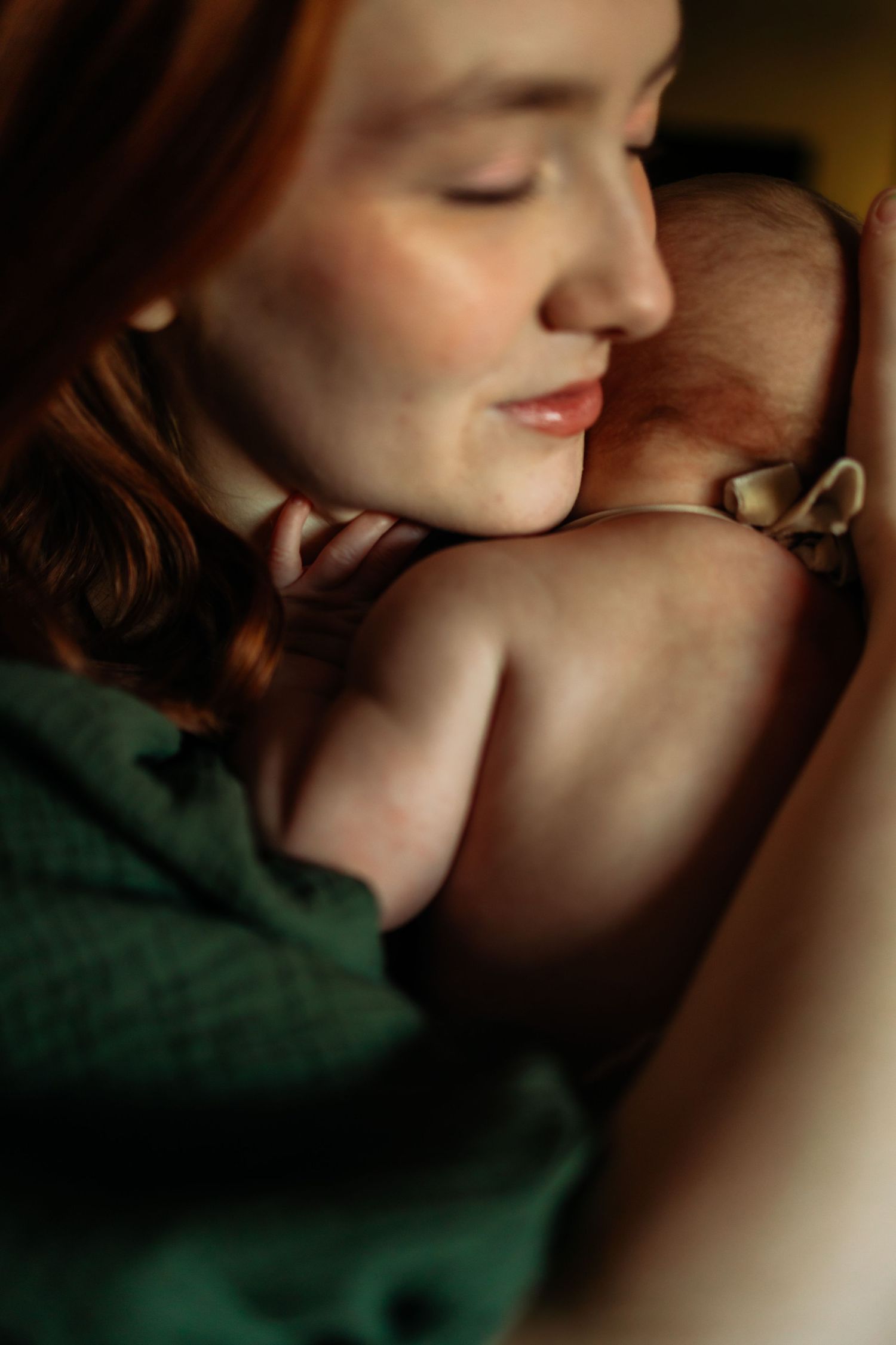 Intimate close-up portrait showing tender expressions in warm lighting.