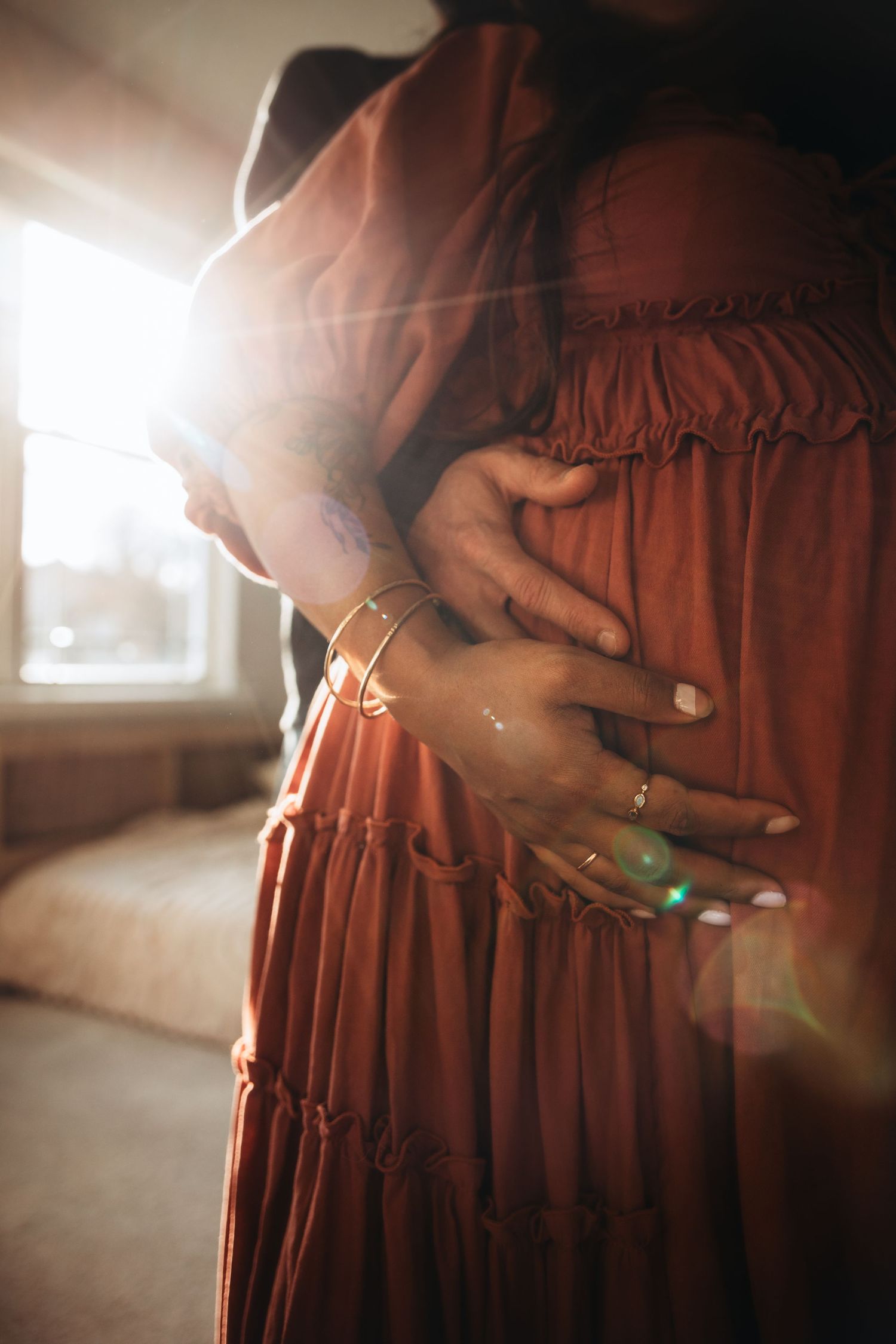 A series of cropped photos showing a person in a flowing rust-colored dress with sunlight creating a dreamy atmosphere.