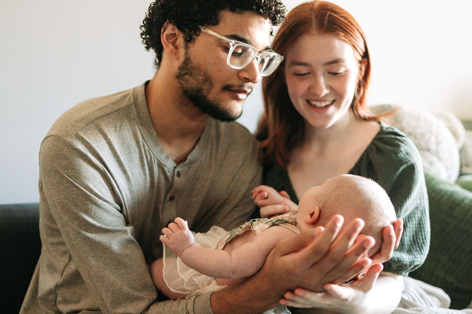 Intimate family moment captured in warm sunlit room.