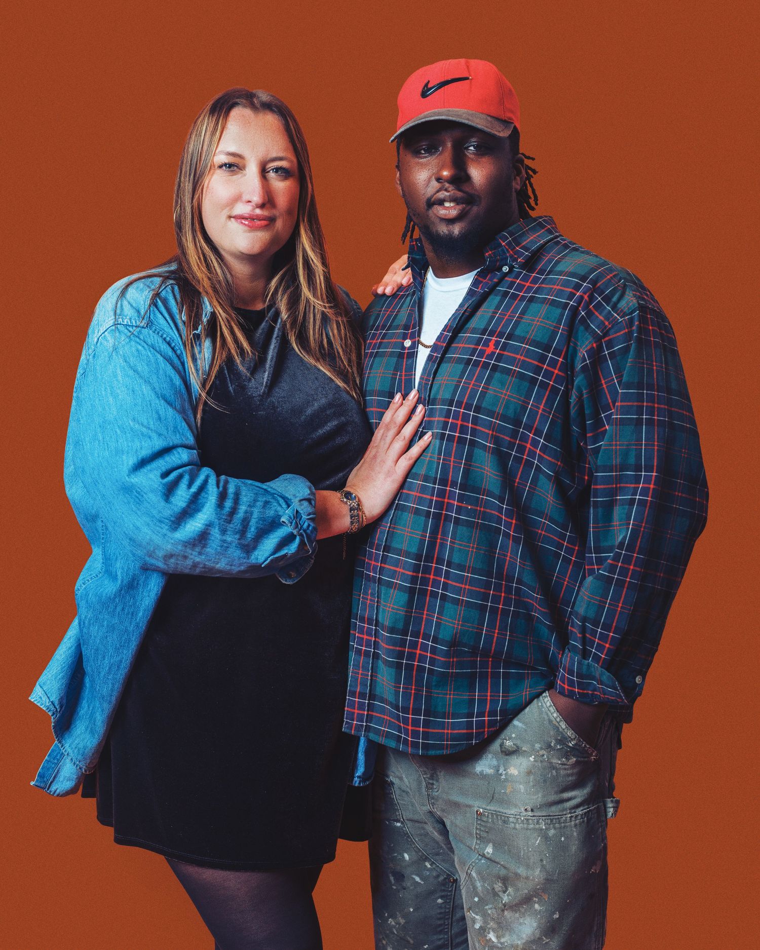 A couple poses together against a brown backdrop in a series of four progressive shots showing playful interaction.