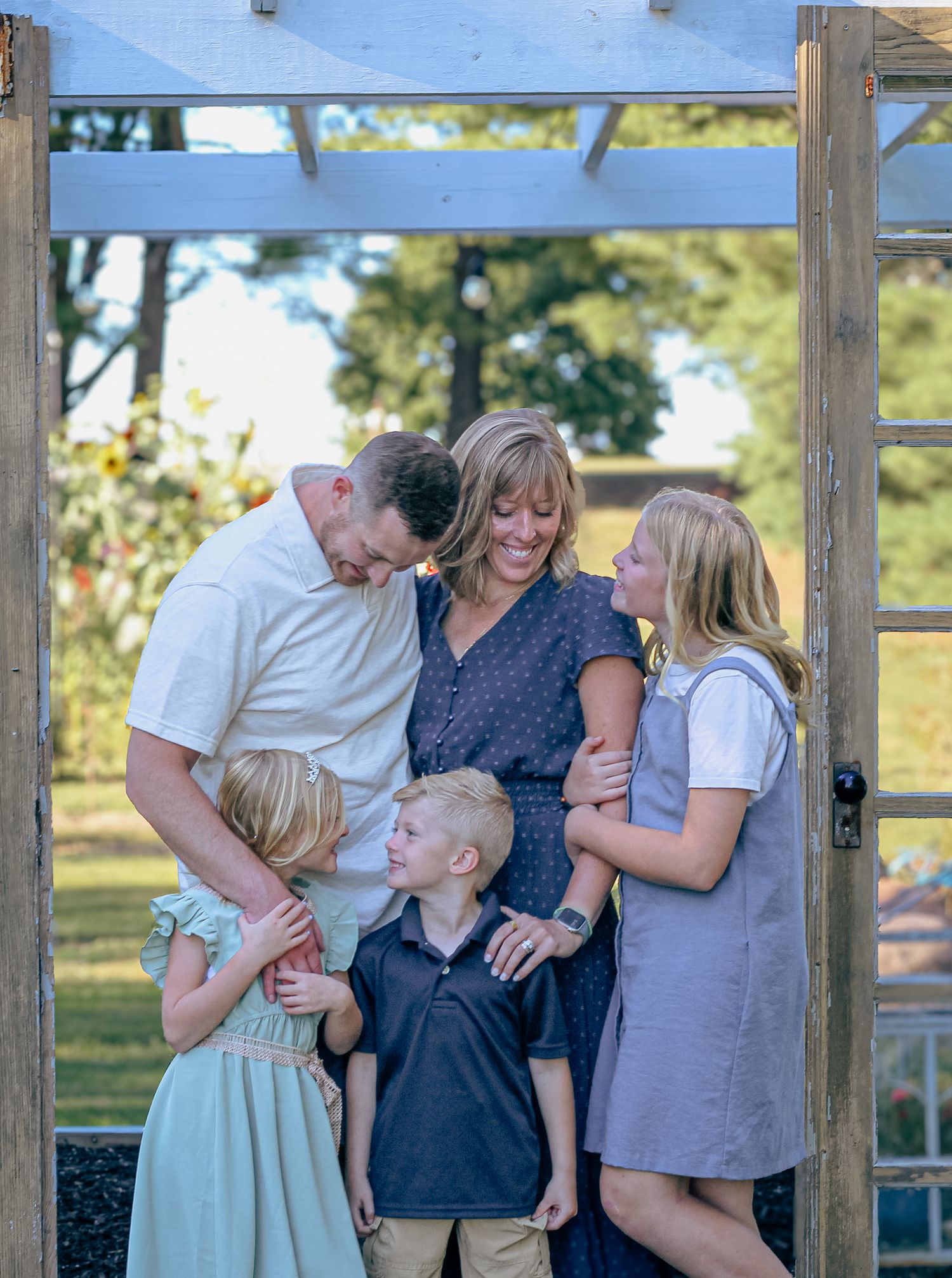 a family smiling and laughing at one another