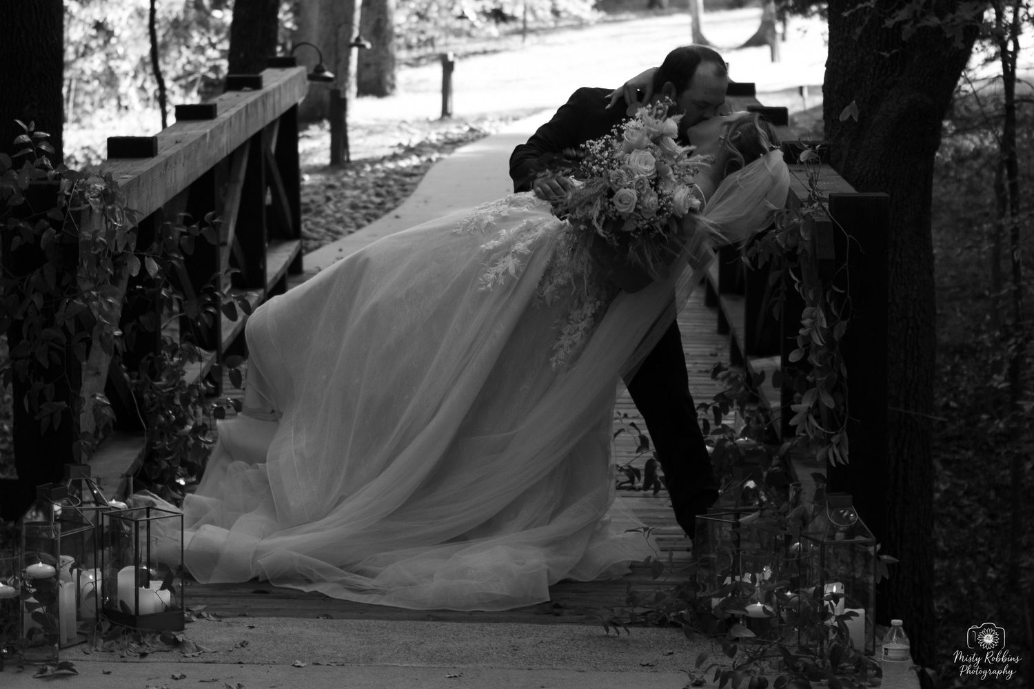 Black and white wedding photos show a bride in a flowing gown walking through an outdoor garden setting.