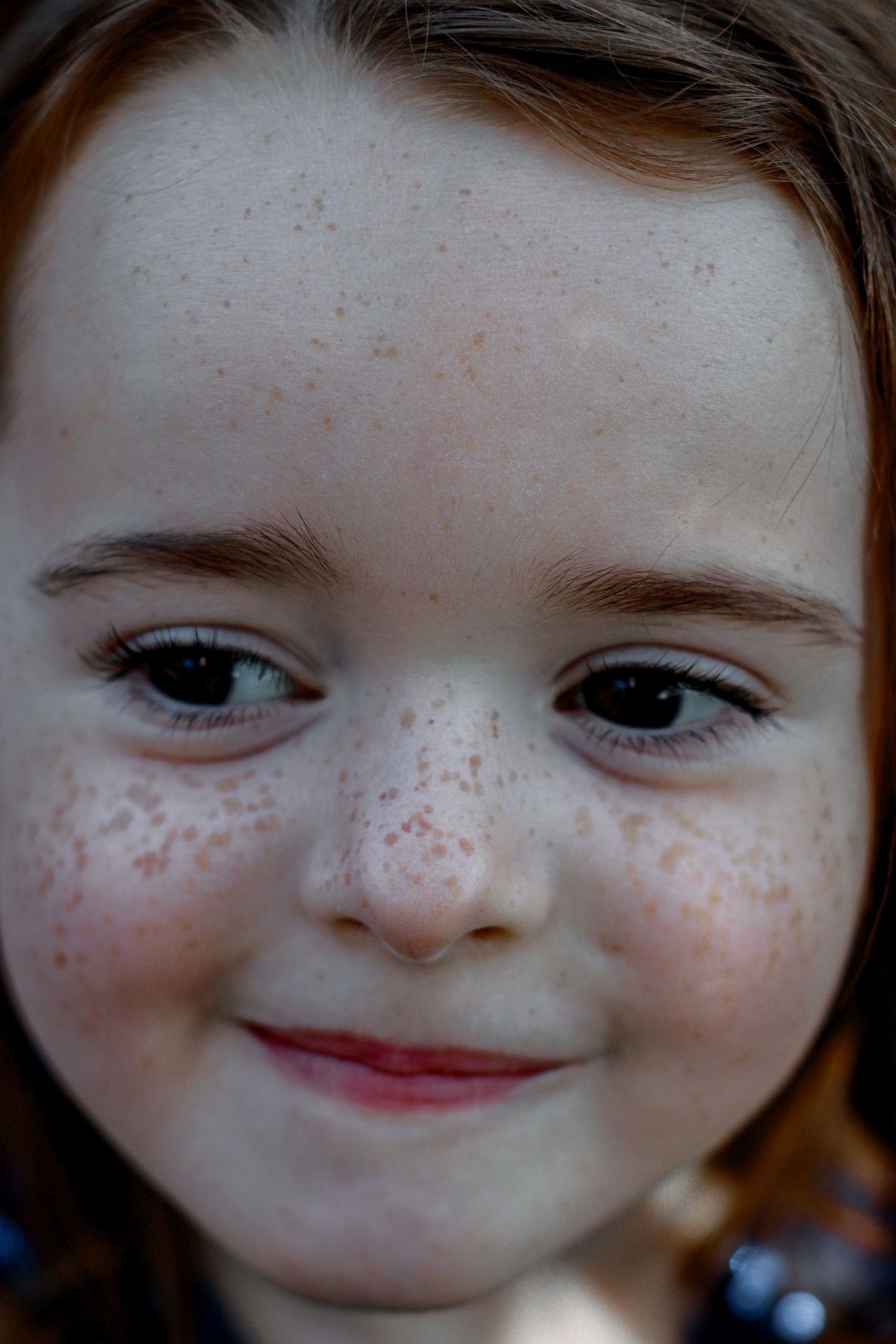 Close up portrait shots showing adorable freckles and expressive eyes.