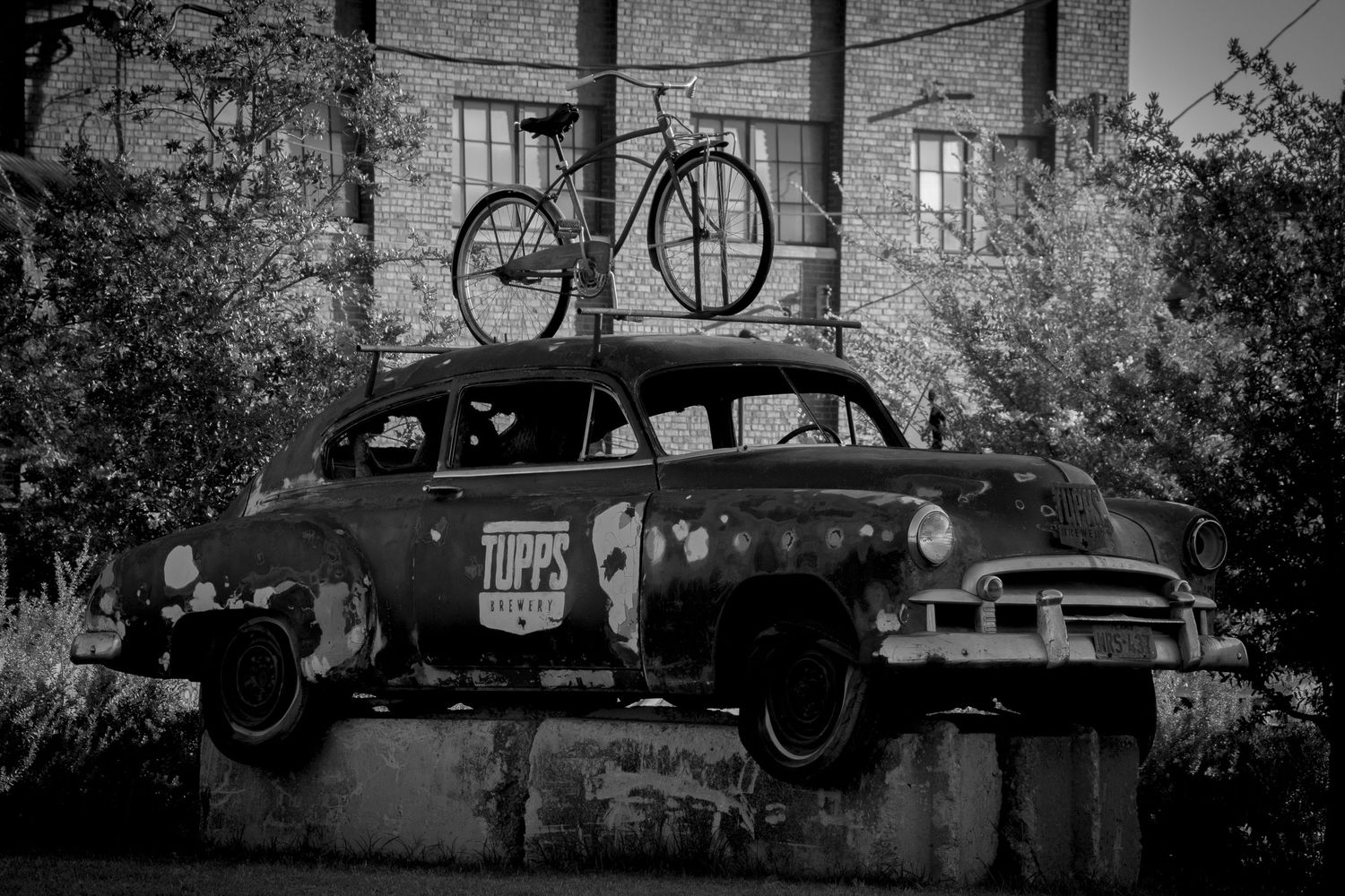 A series of black and white photographs showing vintage cars and scenes from what appears to be the 1930s era.