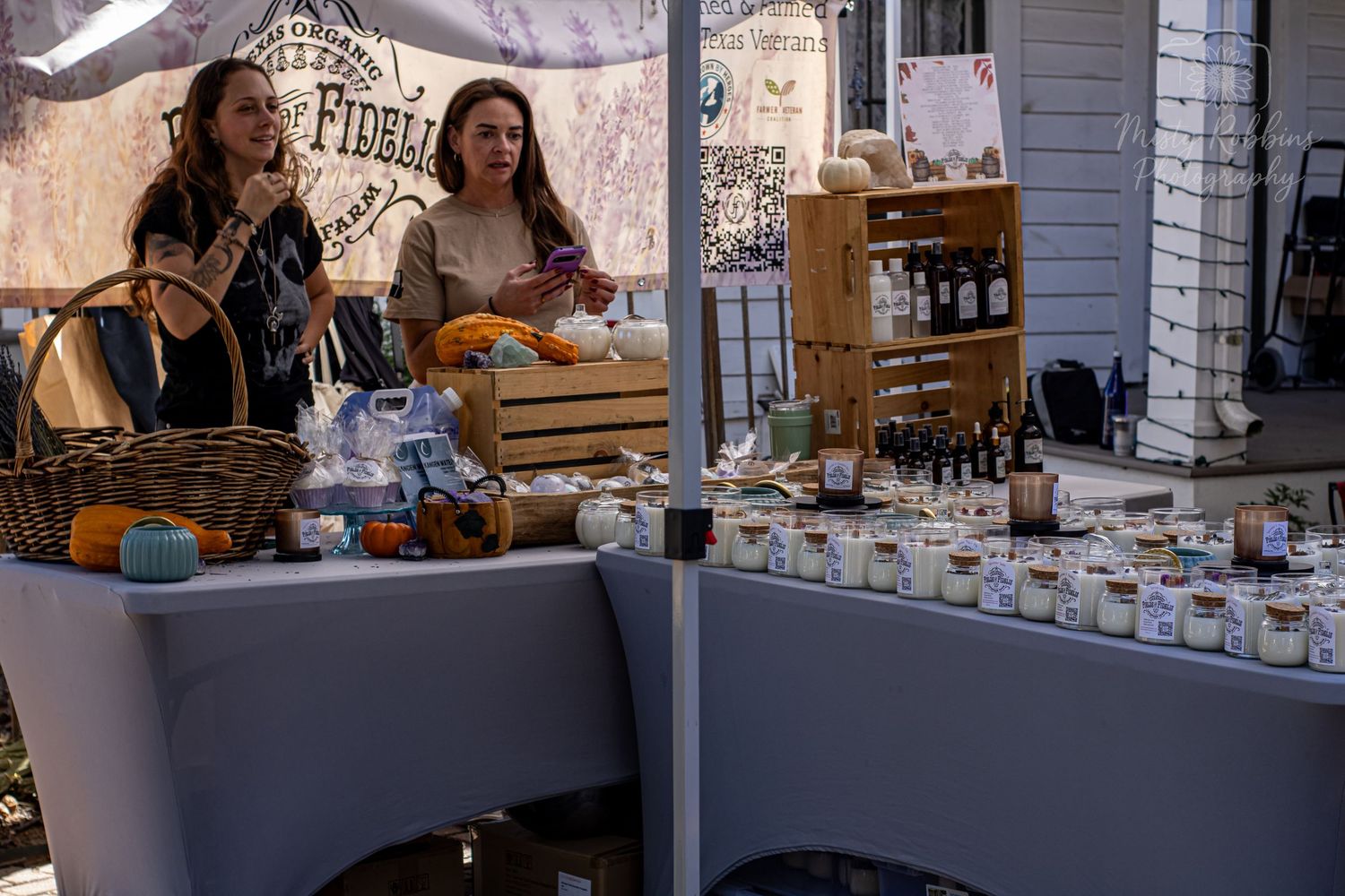 Vendor stalls displaying various goods and merchandise at an outdoor market.