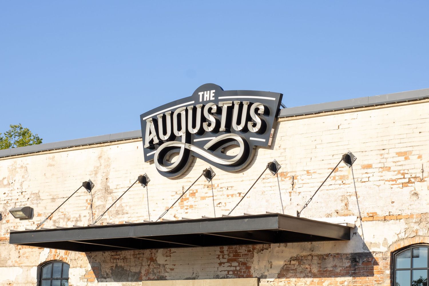 Vintage brick building facade with signage and architectural details.