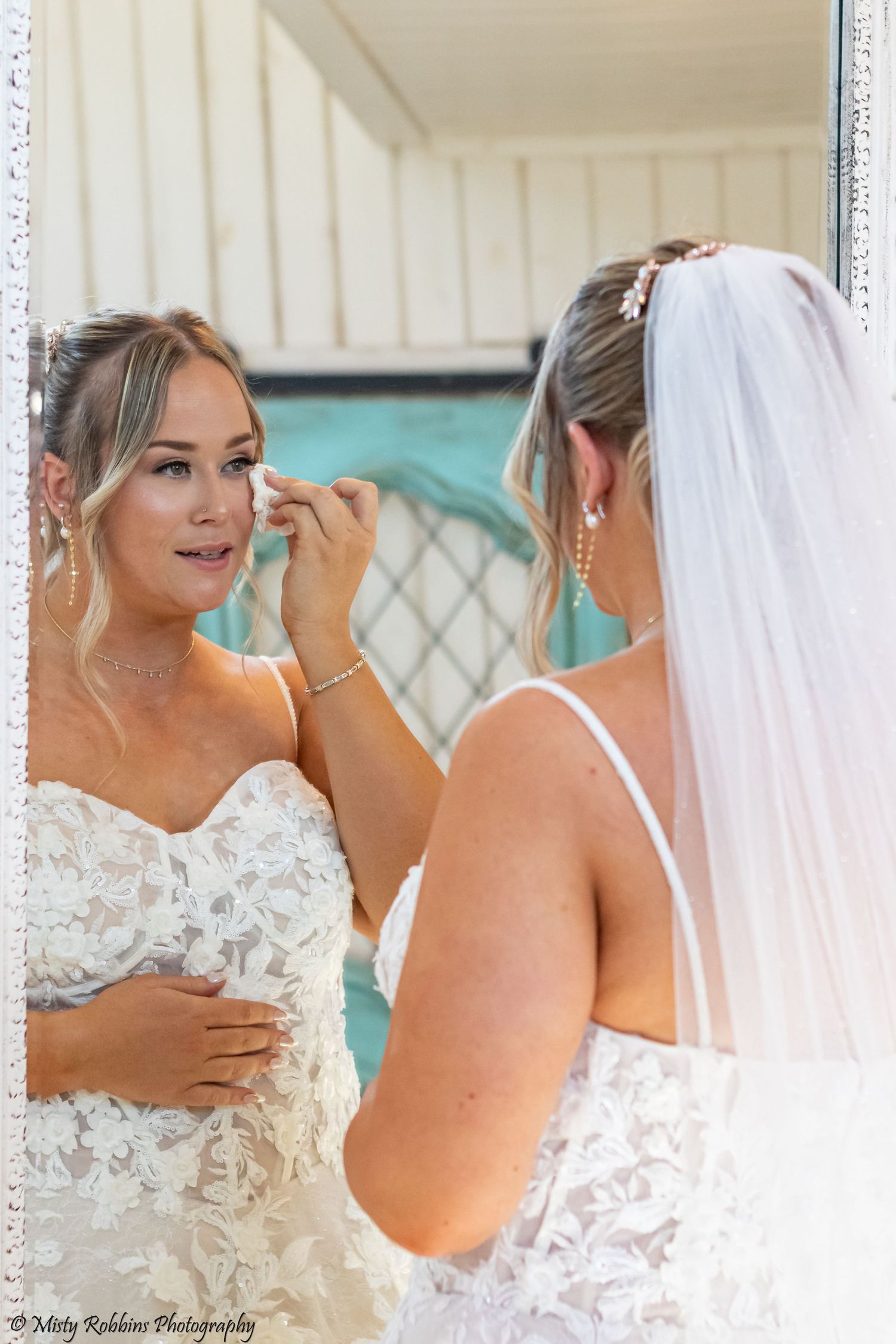 Candid wedding photography series showing bride getting ready with final makeup touches and adjustments to her veil.