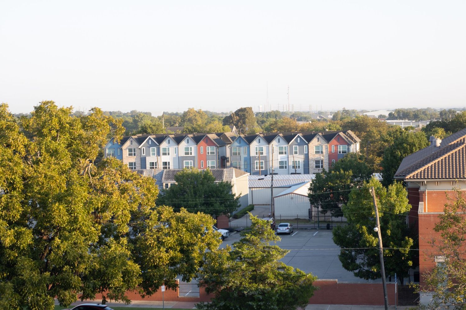 Panoramic view of colorful townhouses and buildings surrounded by autumn trees.