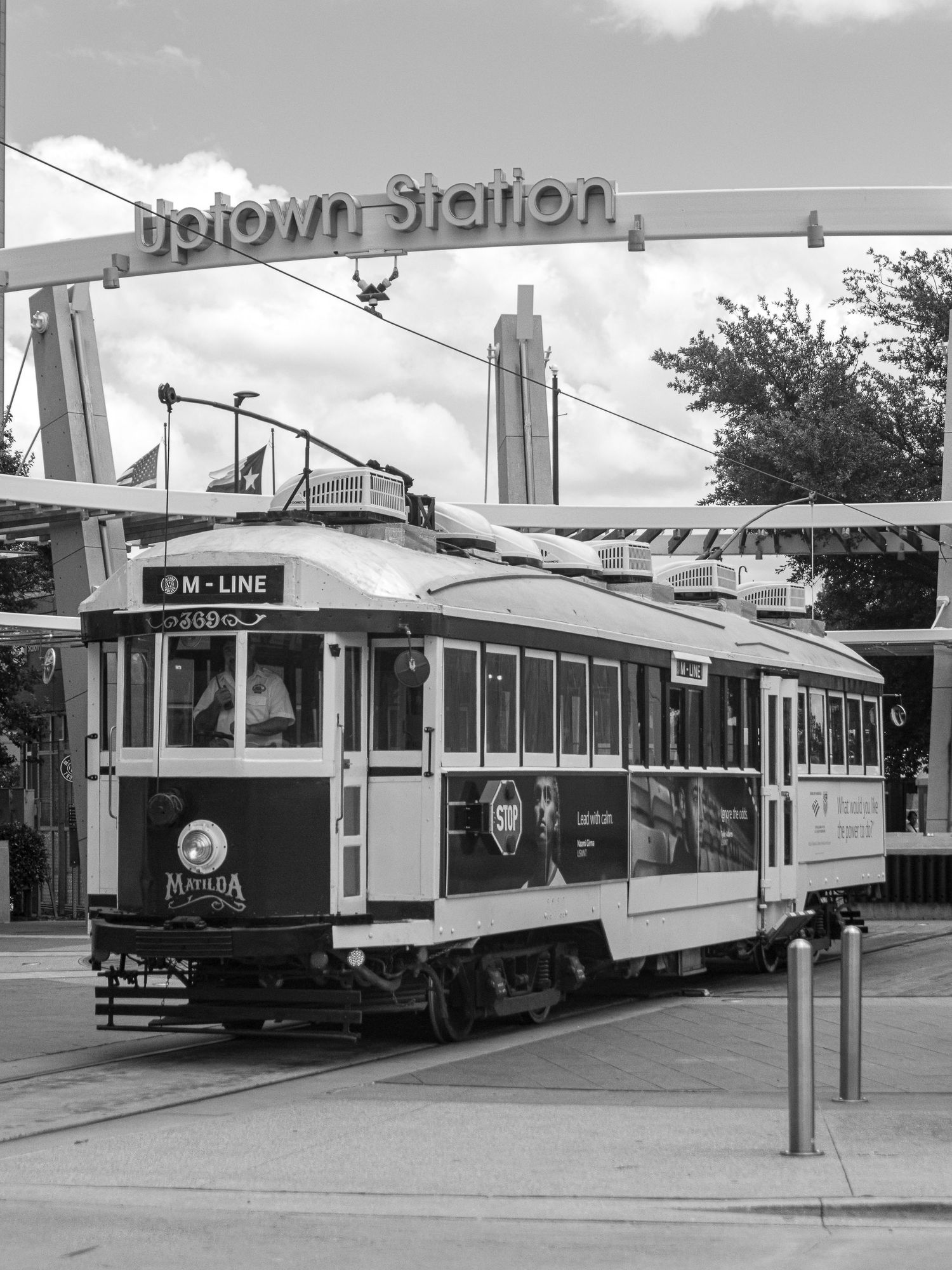 Black and white photo of the M-Line trolley streetcar at Uptown Station in Dallas, Texas.