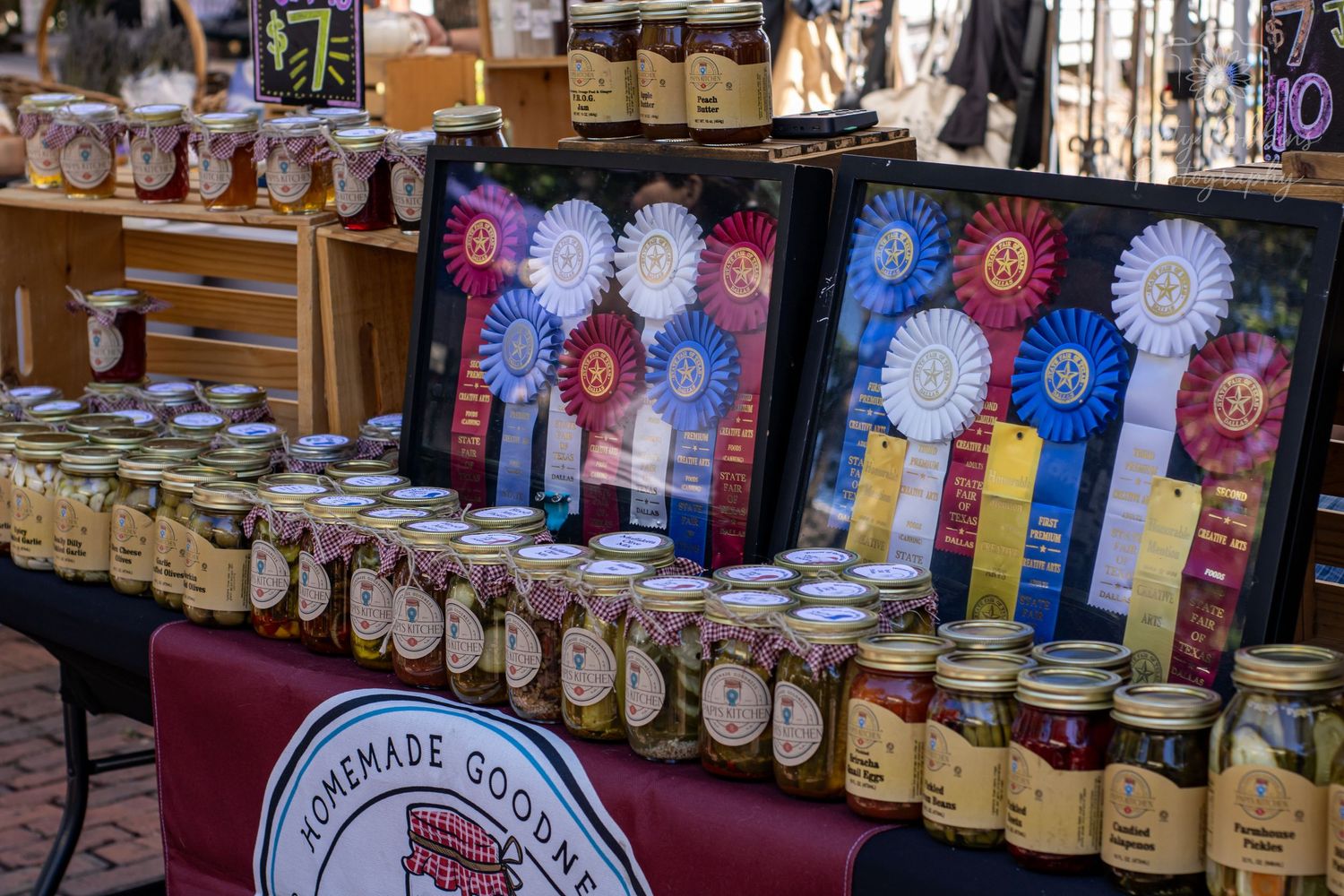 Display of colorful award ribbons and trophies arranged on retail shelves at a specialty shop.
