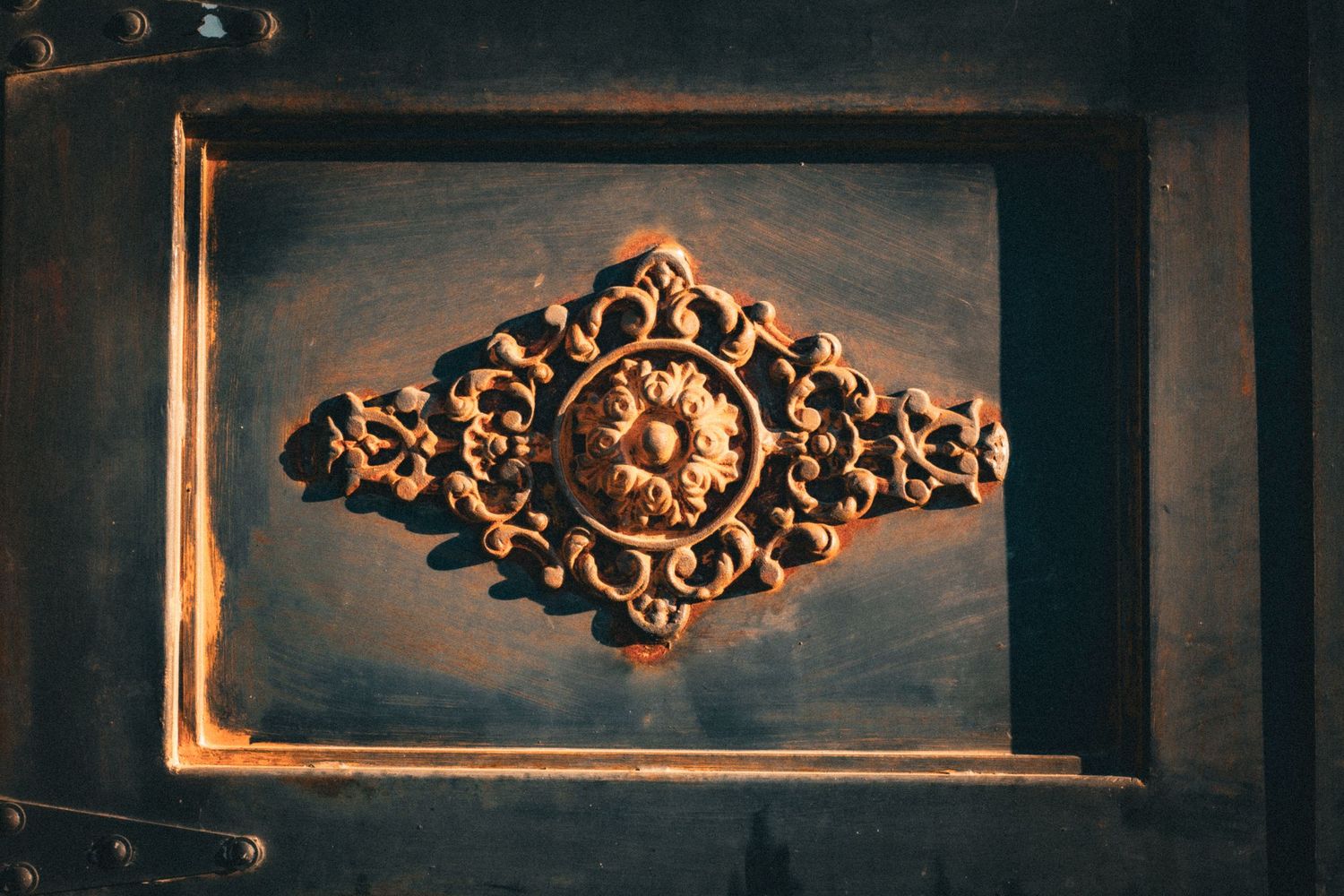 Ornate decorative moldings and architectural details in dark vintage setting.