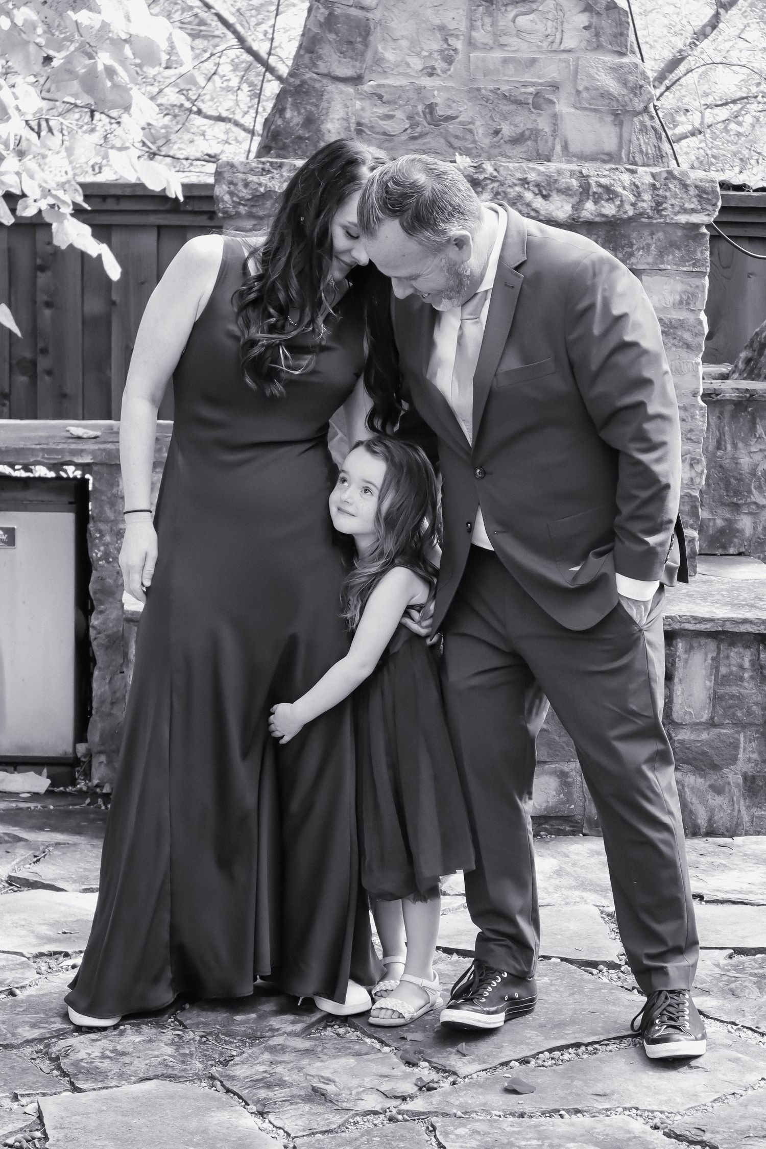 Black and white sequence of formal dress shoes and attire on stone ground.