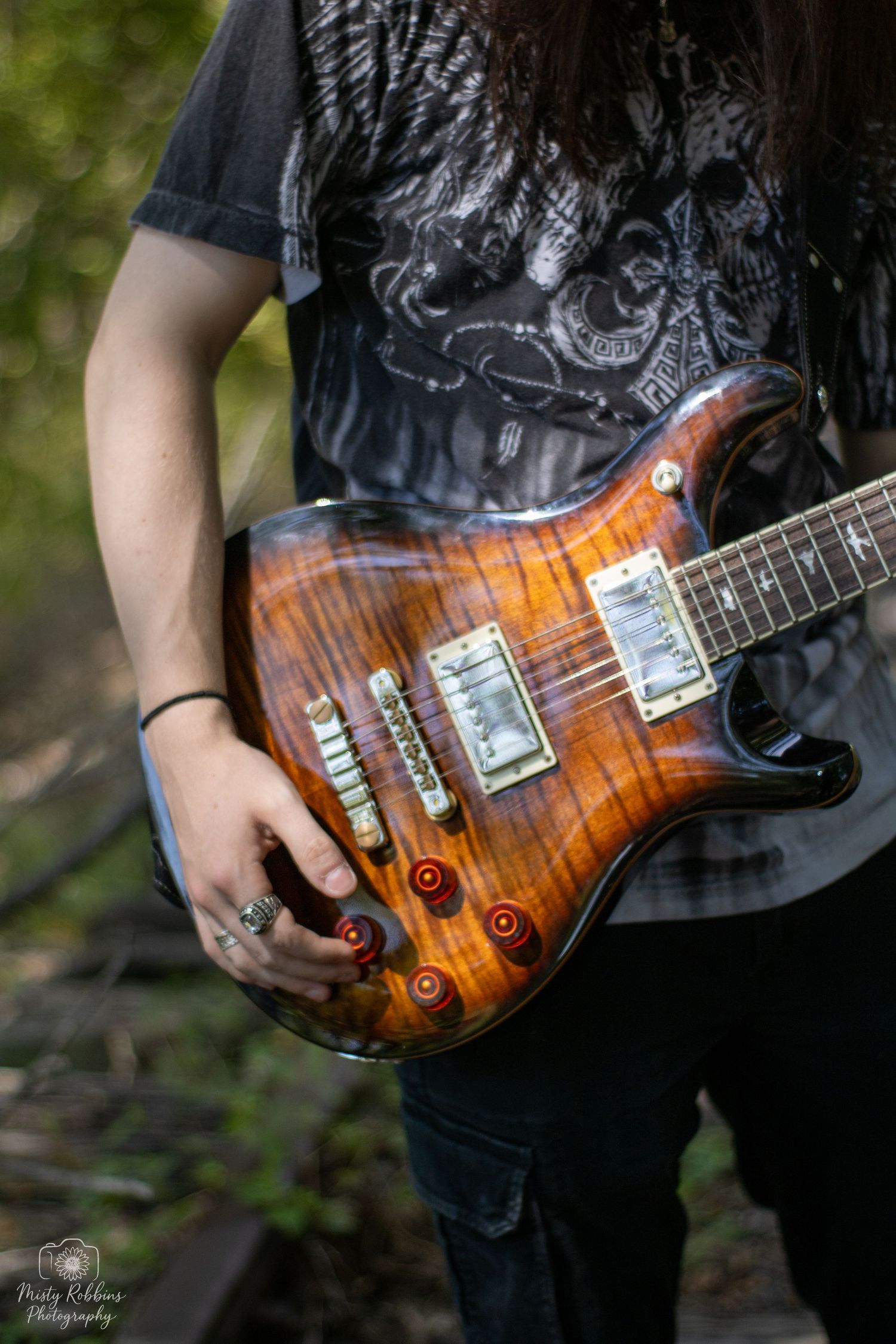 Close-up shots of a sunburst electric guitar with flamed maple top and chrome hardware in natural outdoor setting.