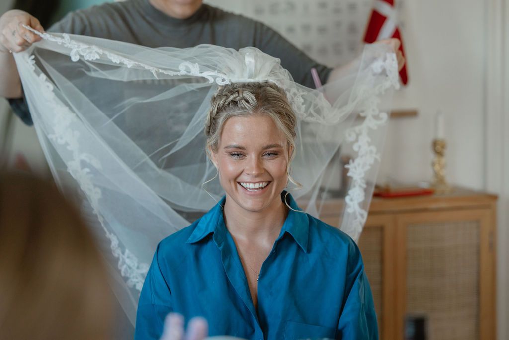 Wedding day preparations with people sharing laughter in a bright room.