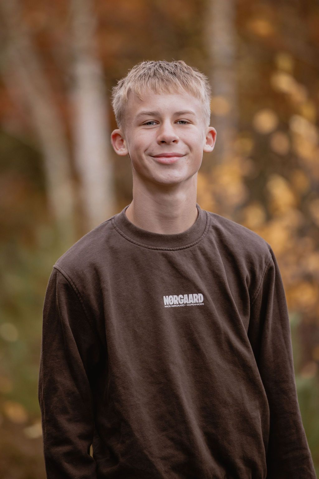 Portrait series showing expressions against blurred fall foliage.