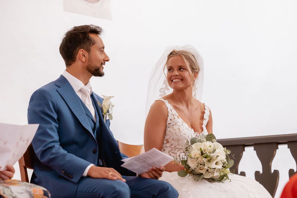 Joyful moment during wedding ceremony in white church interior.