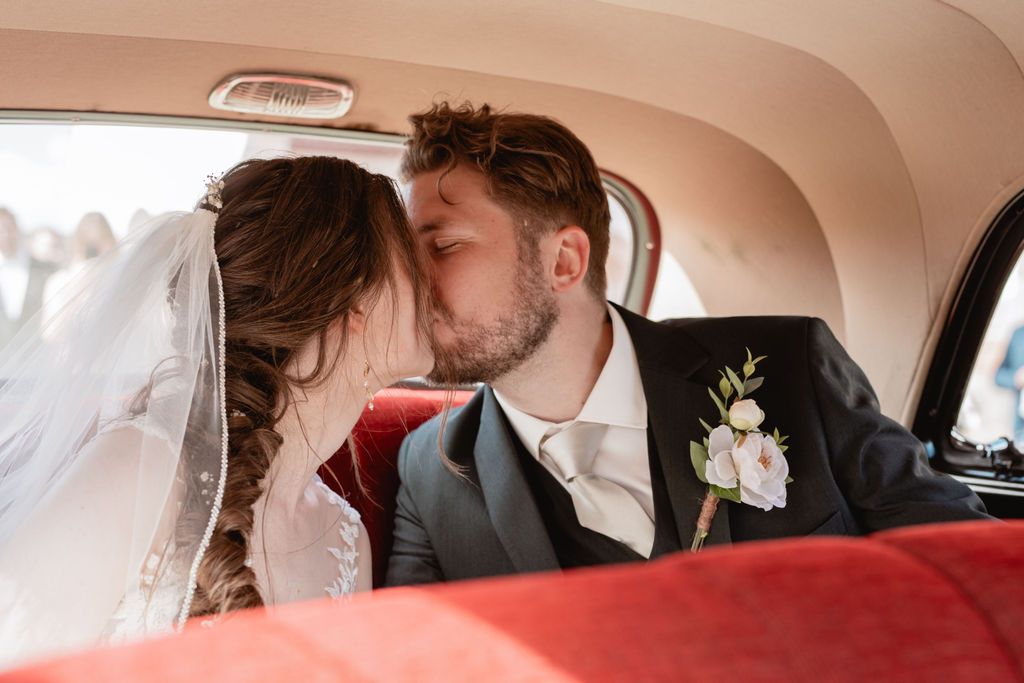 Interior of vintage car with romantic wedding moments captured.