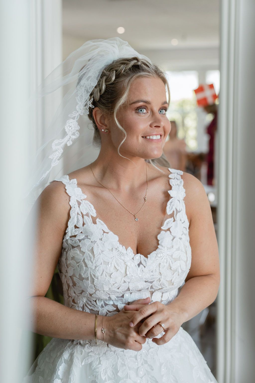 Beautiful lace detail on a white wedding dress with delicate veil.