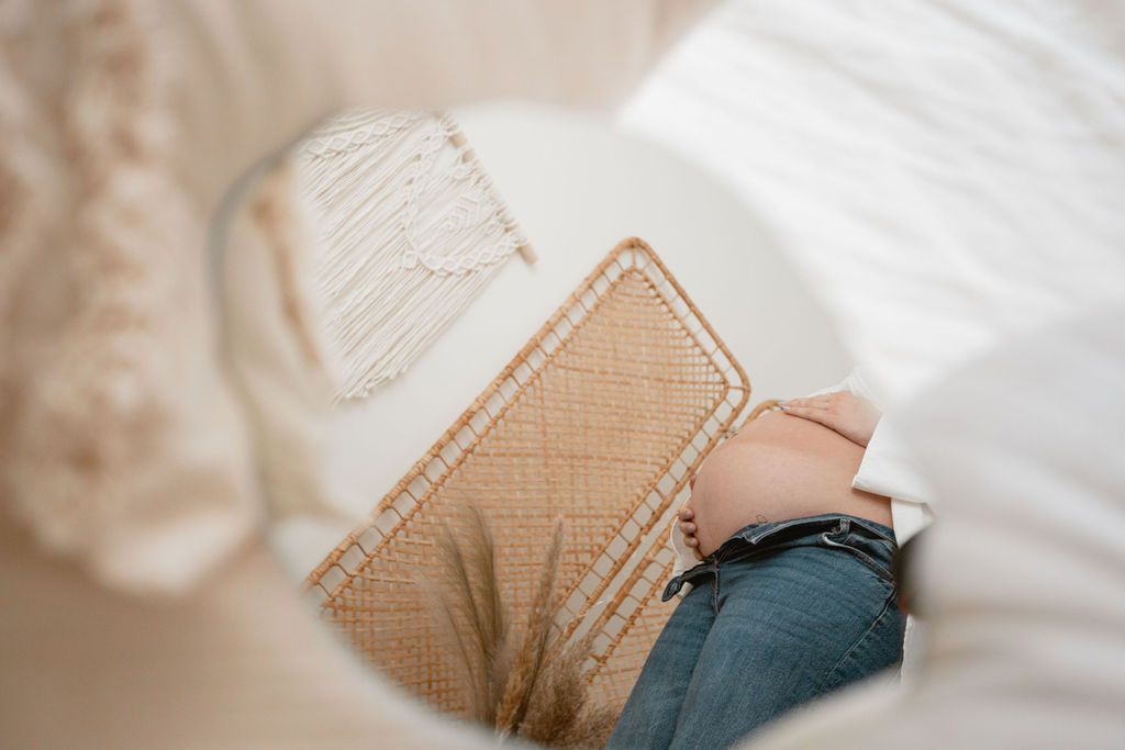 Close-up details of a cream knit sweater in soft window lighting.