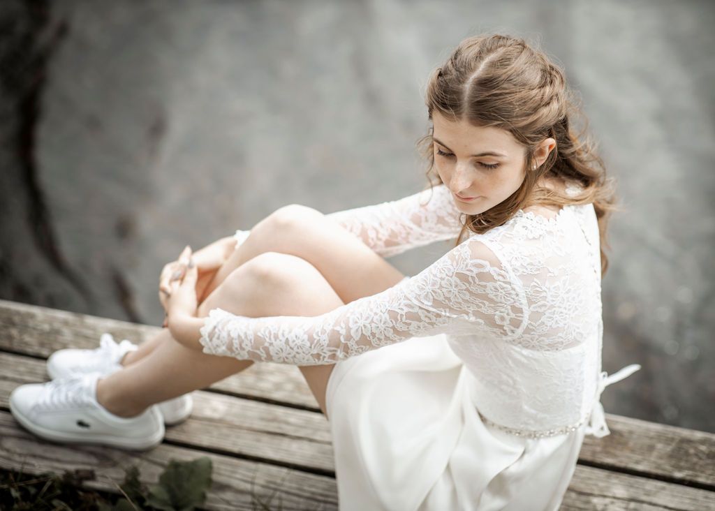 Series of candid moments captured of person wearing elegant white lace wedding gown.
