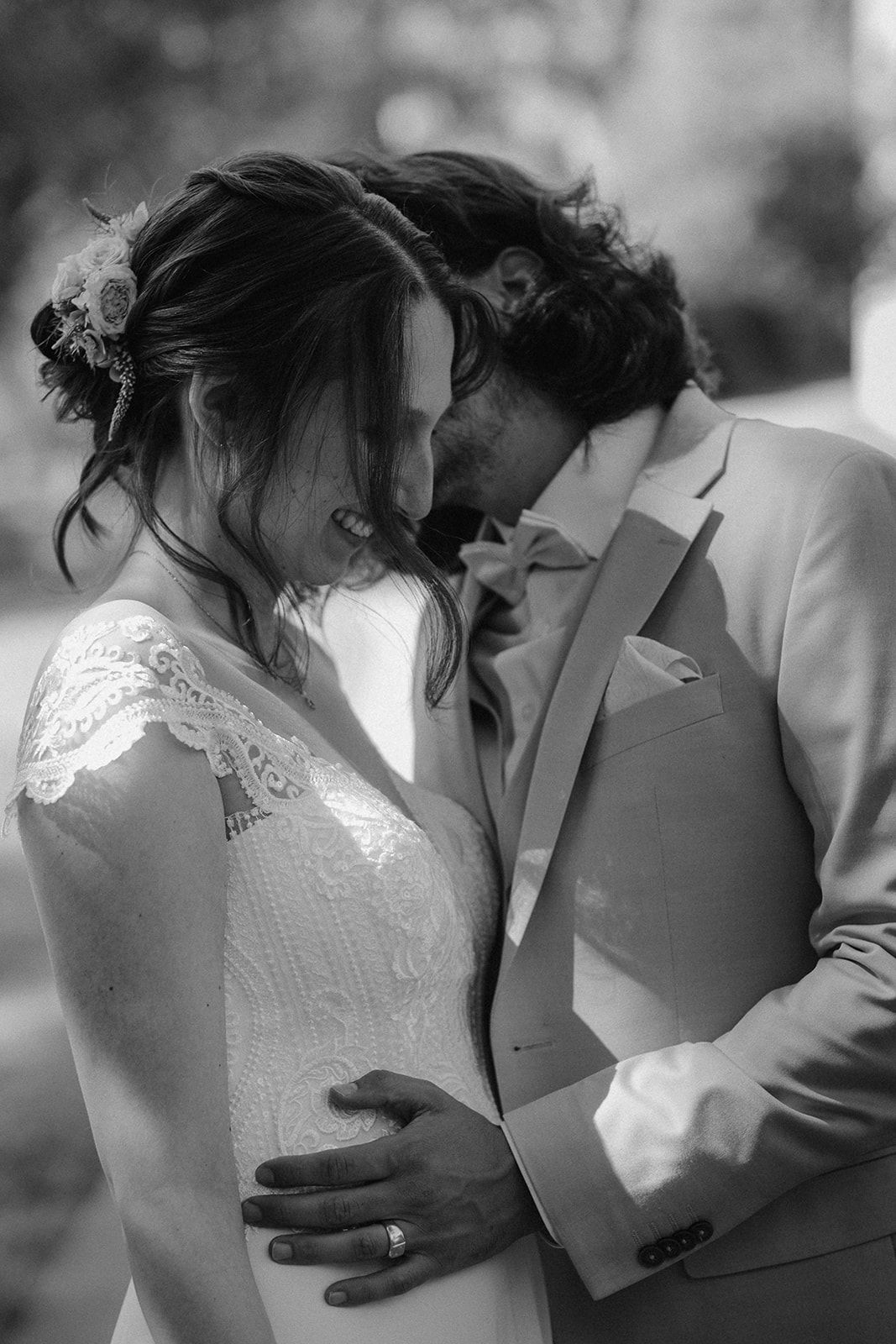 Black and white photo of a bride and groom sharing an intimate moment, the groom kissing her forehead at their wedding. Gut Dietersberg