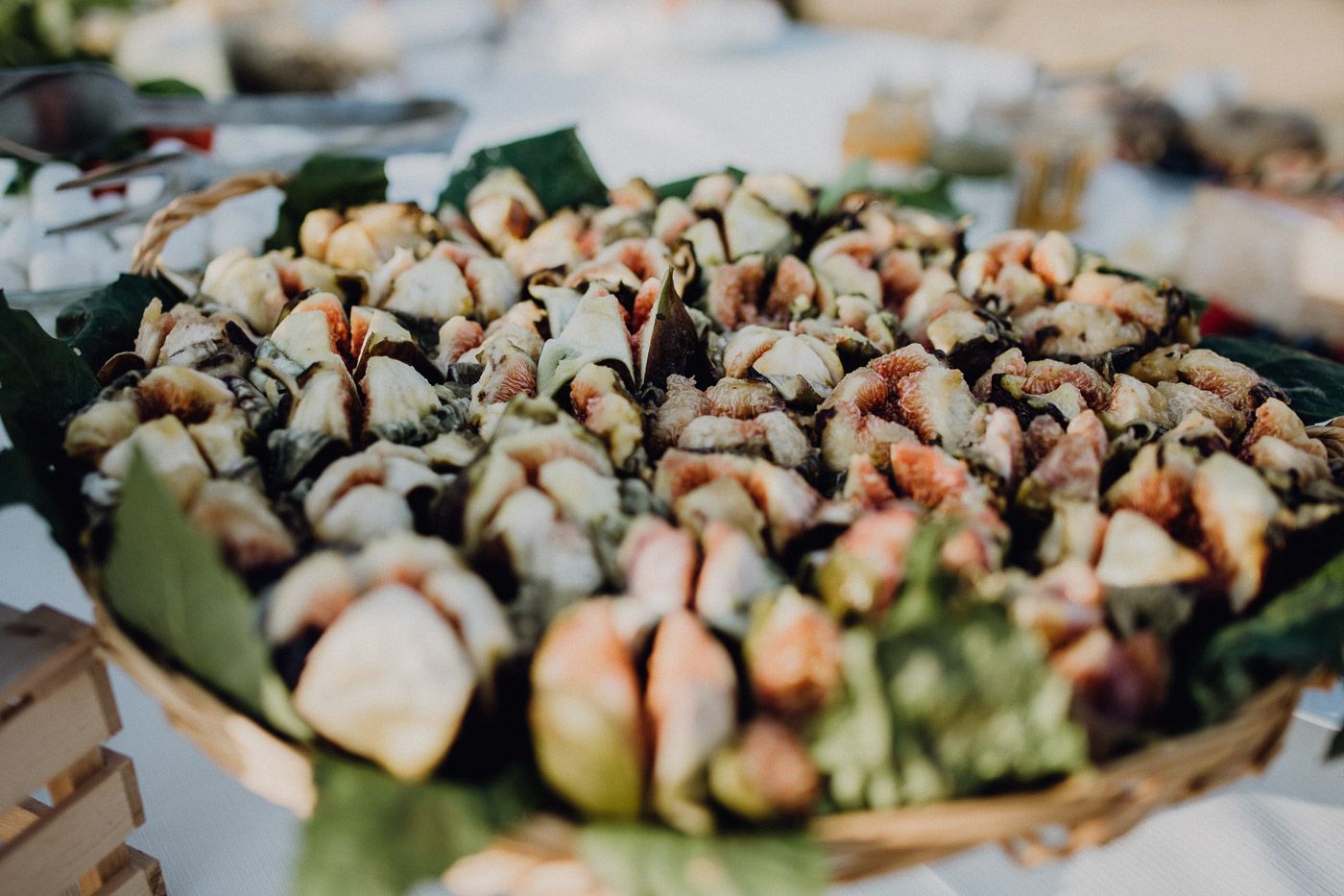 Elegant seafood platter with shellfish and garnishes displayed on tropical leaves at a wedding reception. Tuscany Villa Catignano