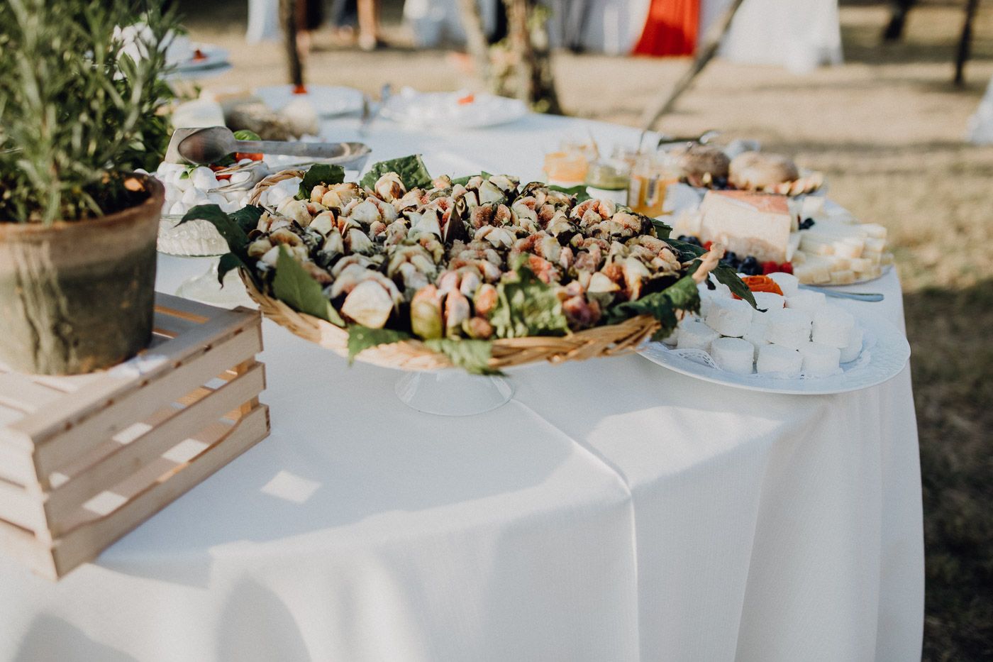 Outdoor wedding reception table with an abundant display of appetizers and finger foods. Tuscany Villa Catignano
