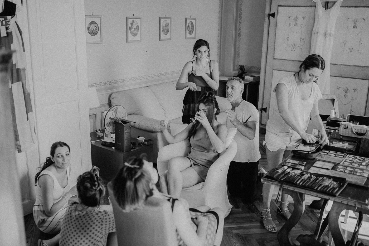 Black and white photo of bridal party getting ready with hair and makeup before the wedding. Tuscany Villa Catignano