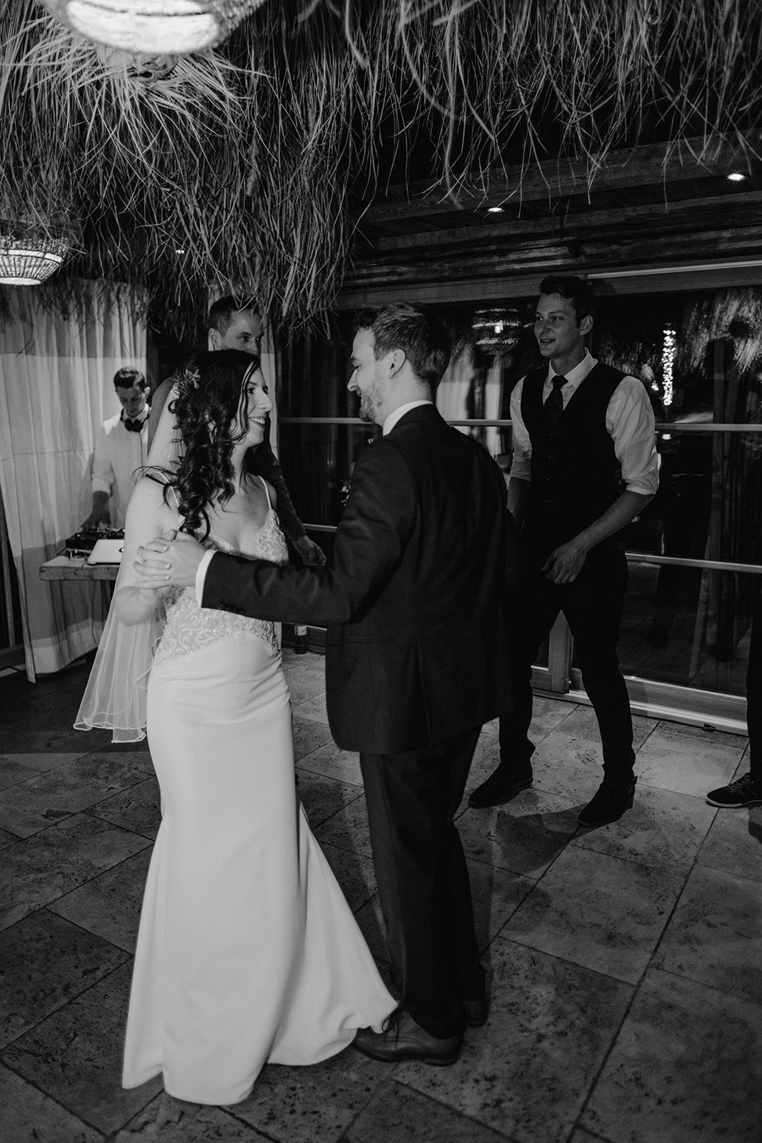 Black and white photo of bride and groom sharing first dance at elegant wedding reception. Jufenalm