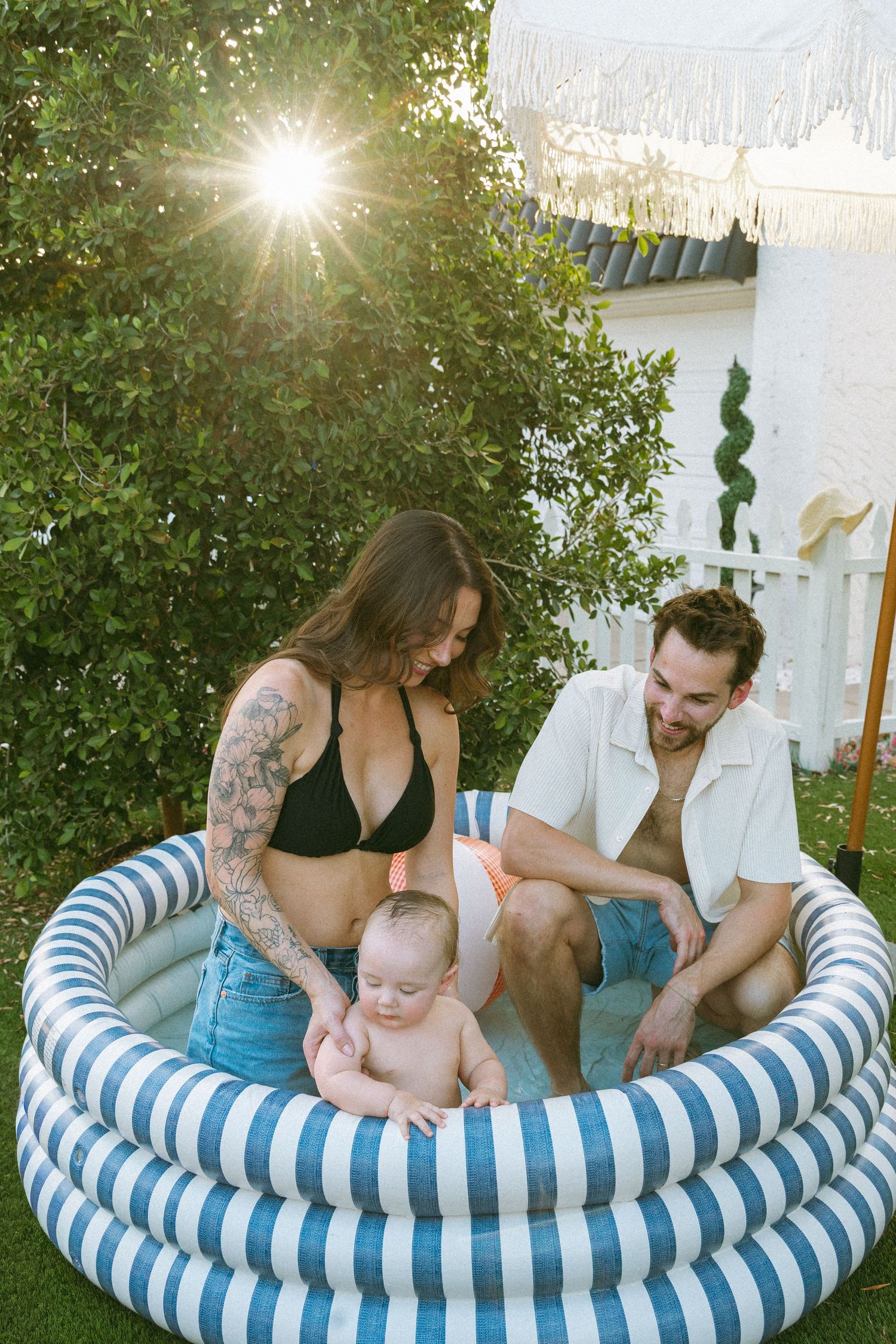 family playing in a small pool