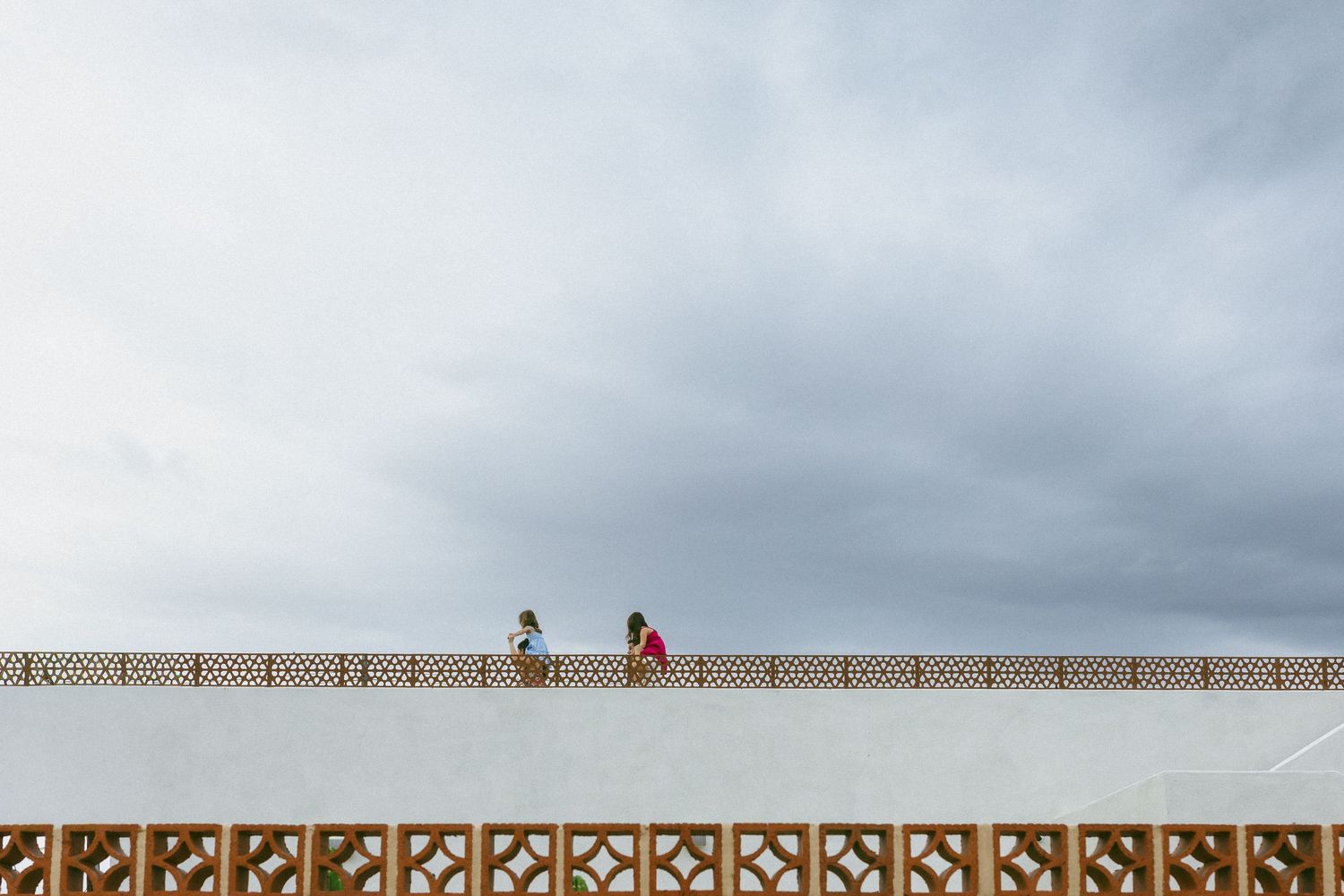 family playing on a rooftop in the rain