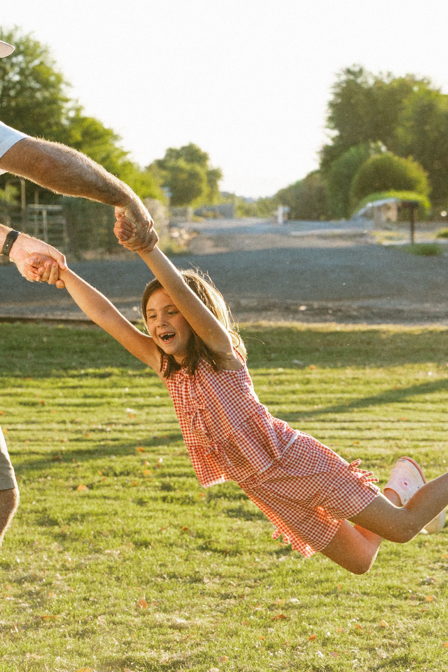 child being swung around by dad during a backyard session